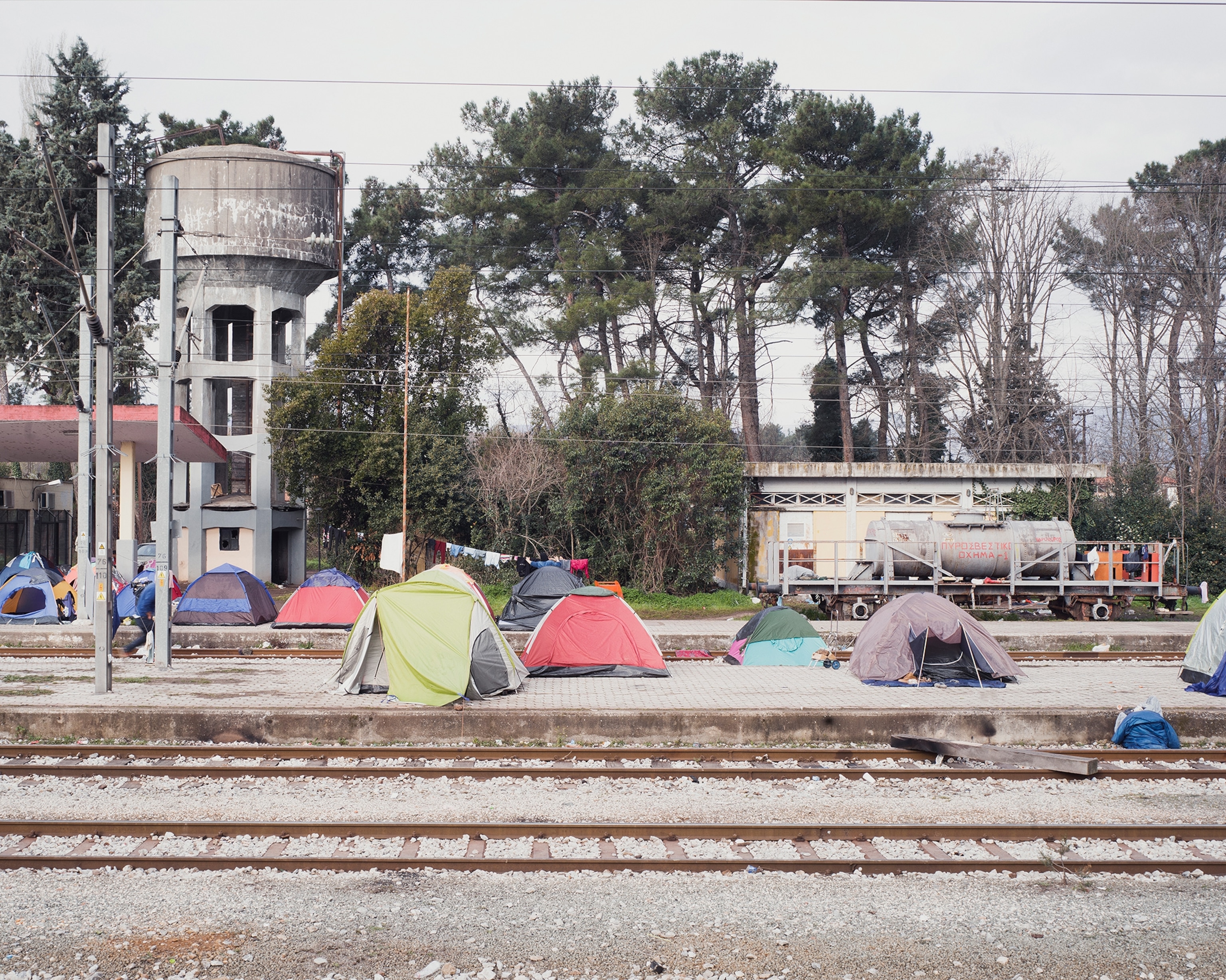 makeshift tents near railroad tracks