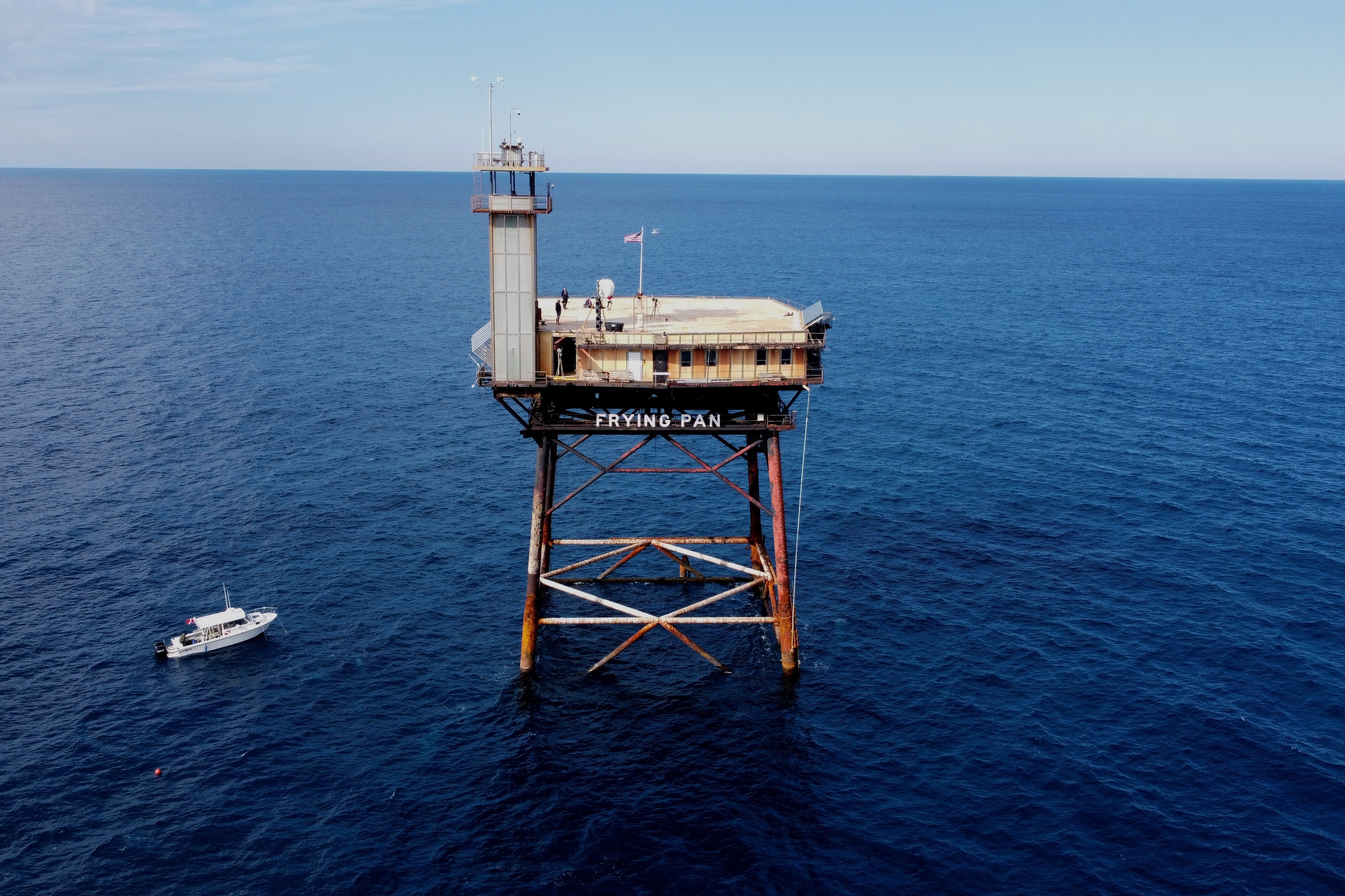 Photograph of the exterior of the frying pan tower lighthouse standing solo in the ocean