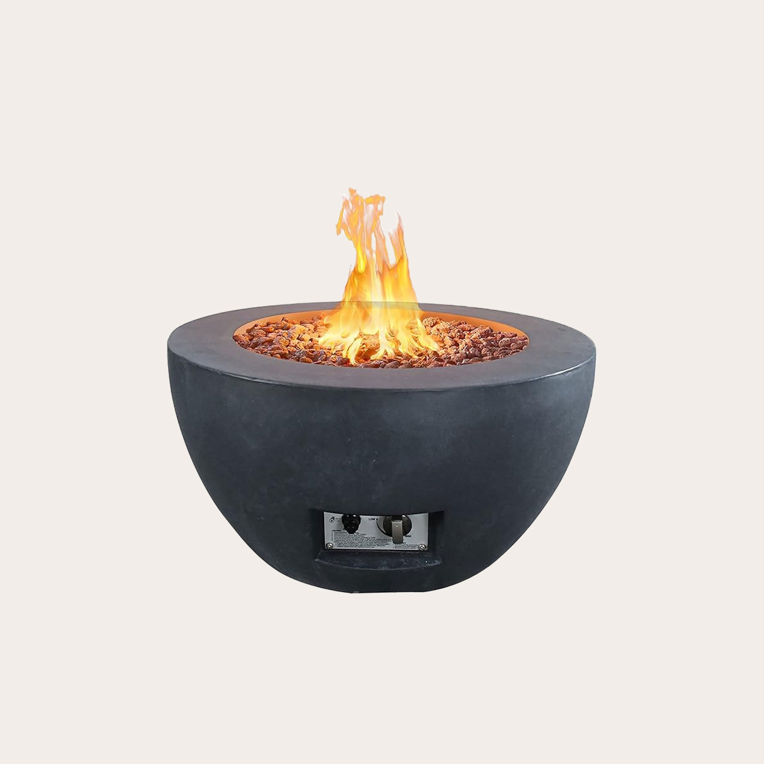 Black cement dome-shaped fire pit with flames placed in front of a tan background.
