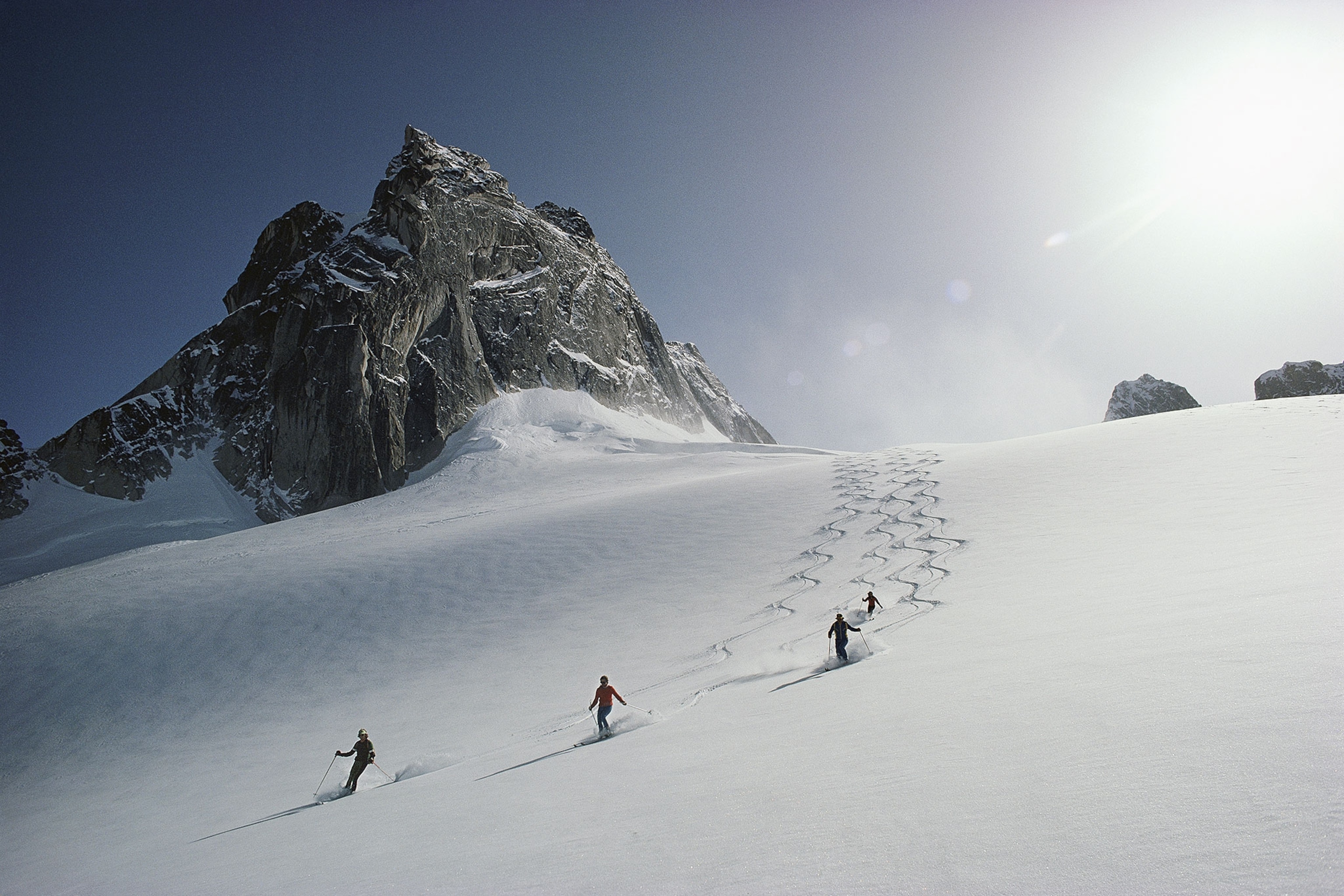 skiers descending Vowel Glacier at Bugaboos Ski Area