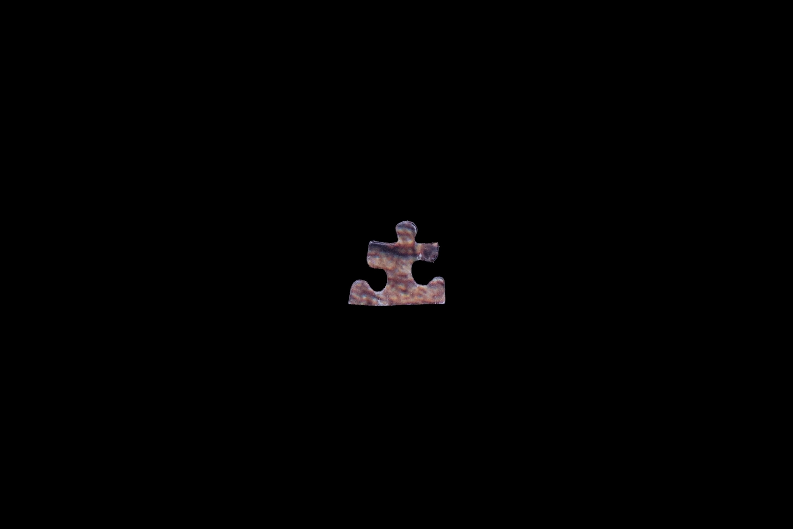 a puzzle piece on a black backdrrop in Puerto Rico