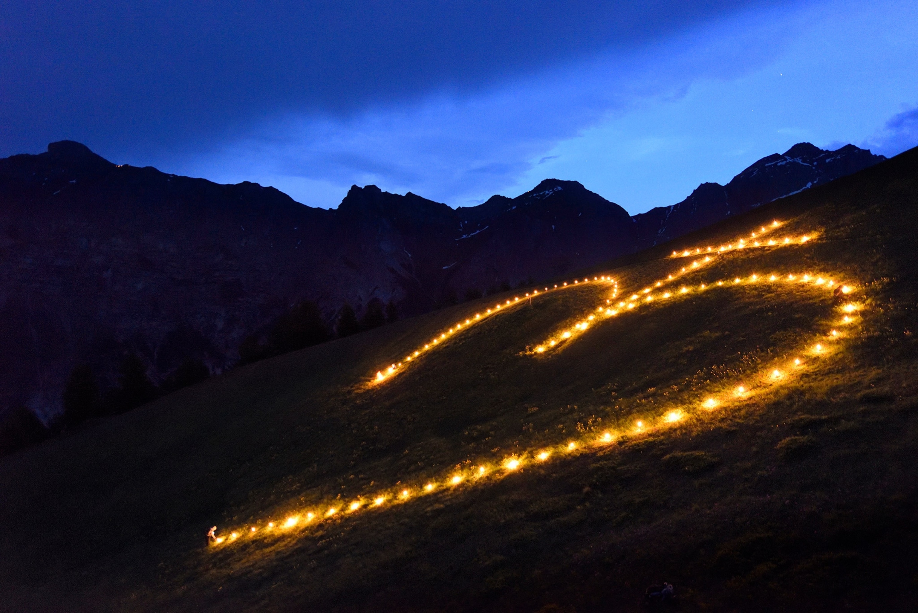 the lighting of a sacred heart fire on Elferspitze mountain in Austria