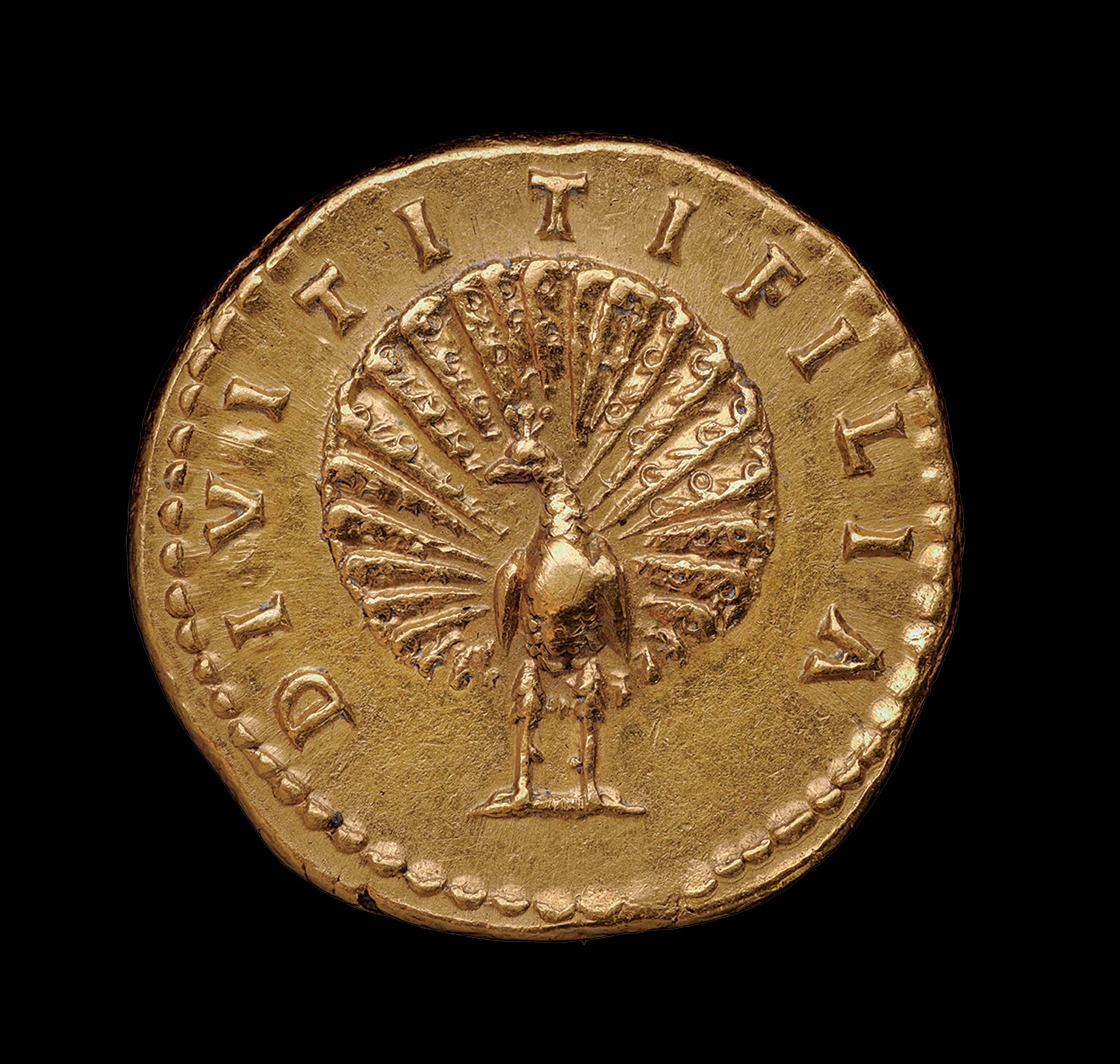 A gold coin has a relief of a peacock