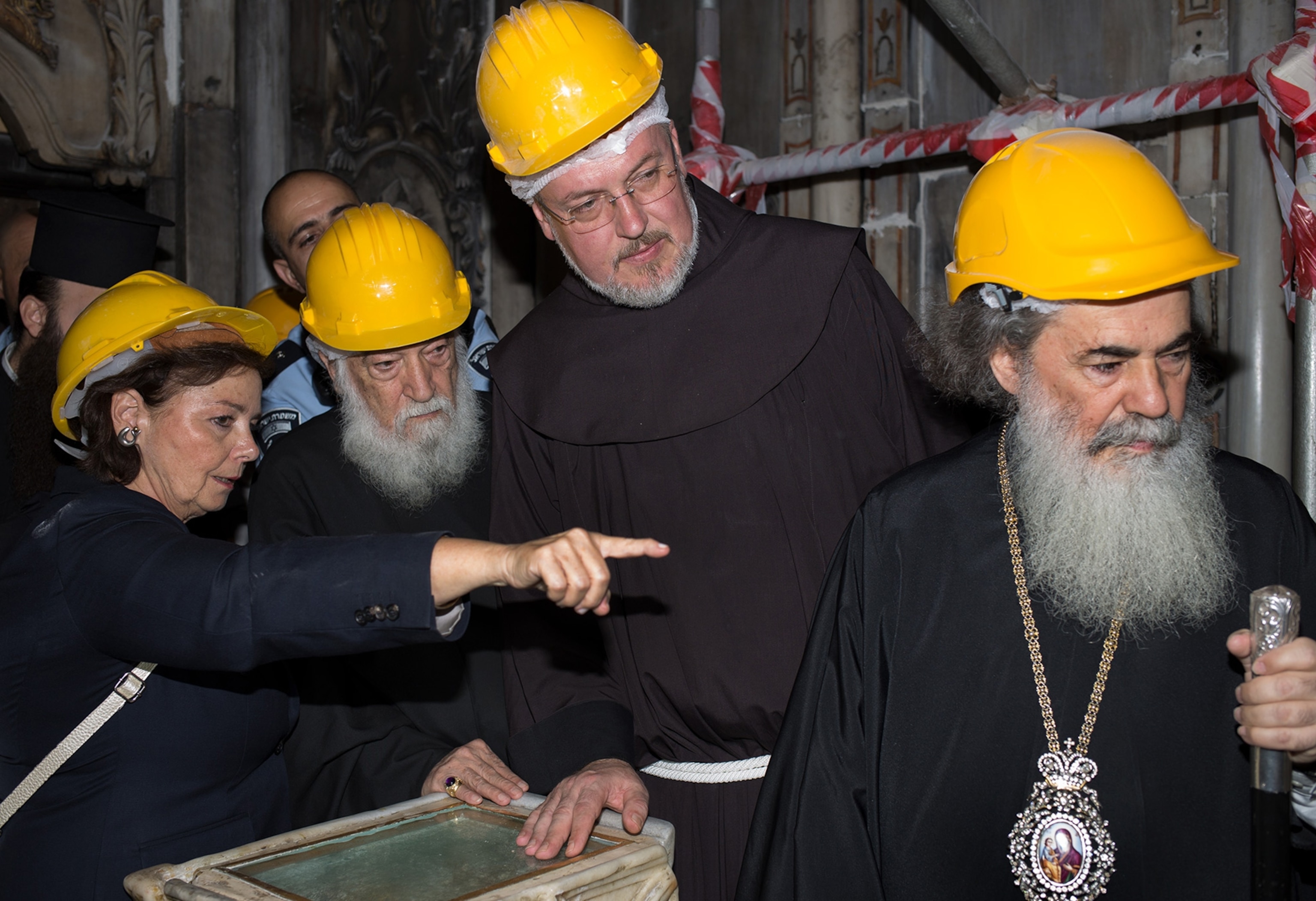 a scientist and Holy men viewing the site