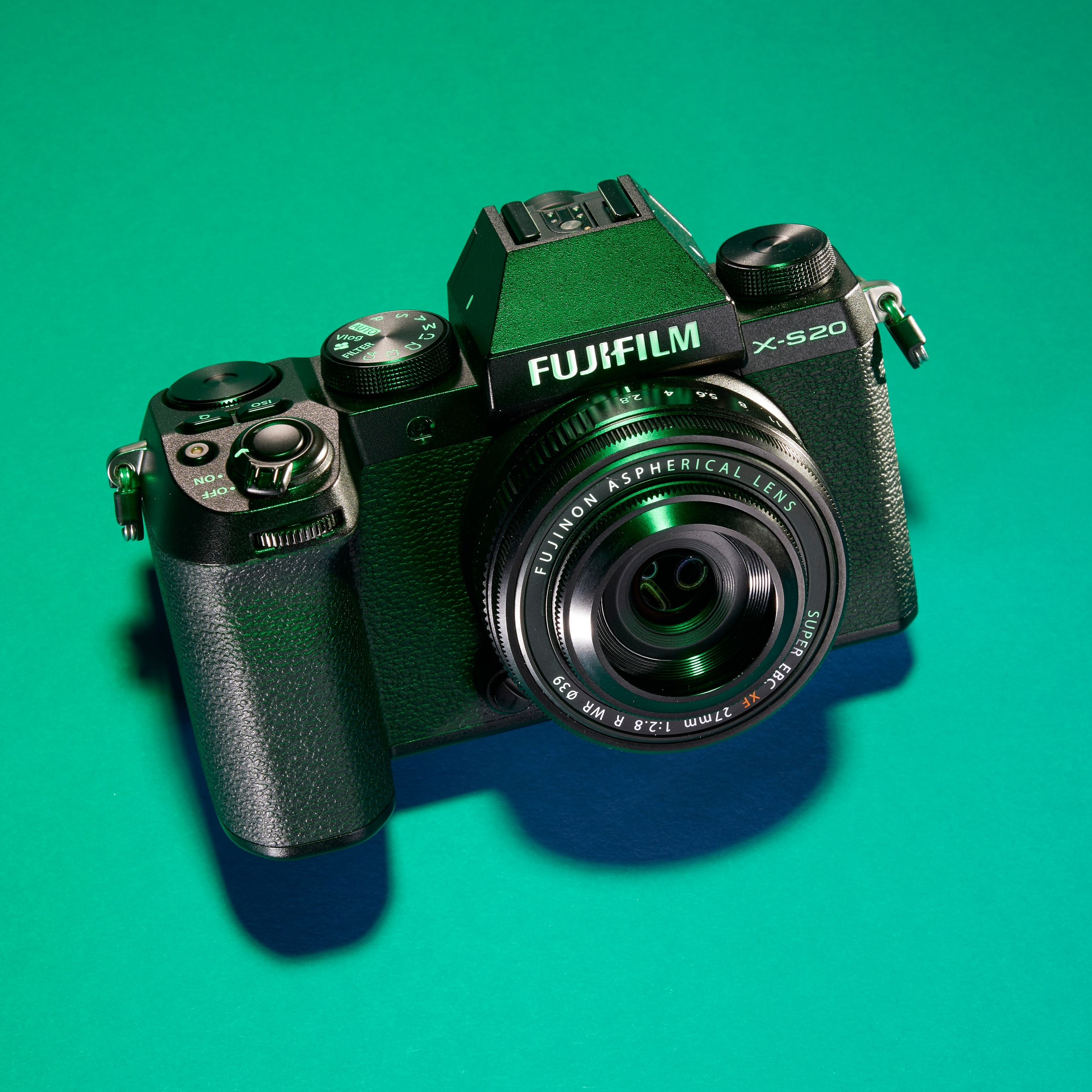 Studio photograph of the Fujifilm X-S20 camera against a green background