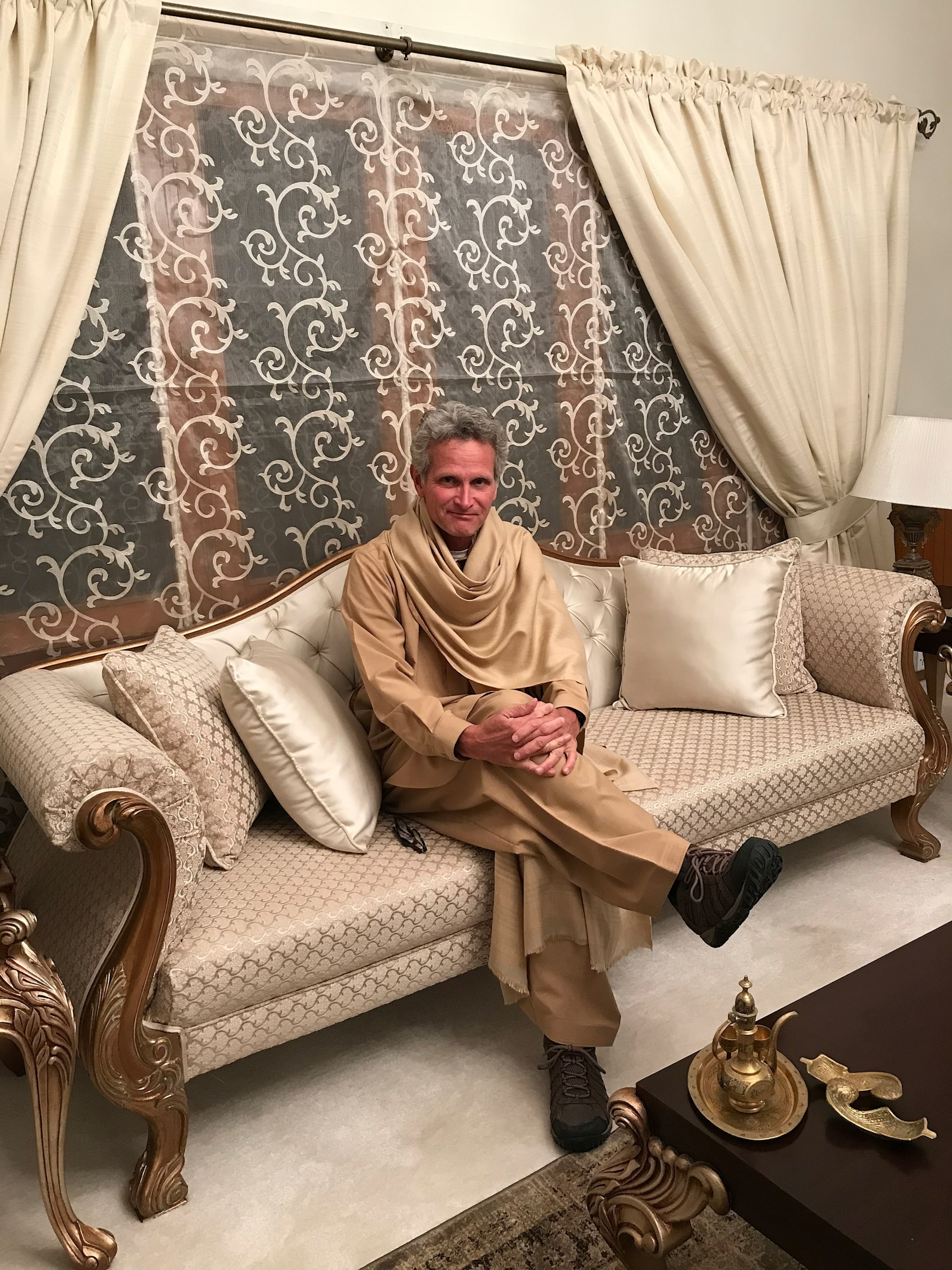 Photo of Paul Salopek seated on couch