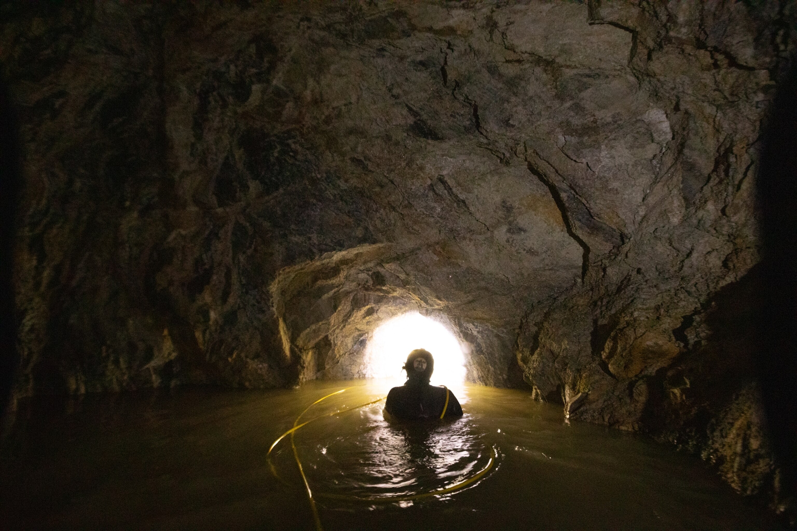 Picture of person inside the tunnel looking toward its entrance.