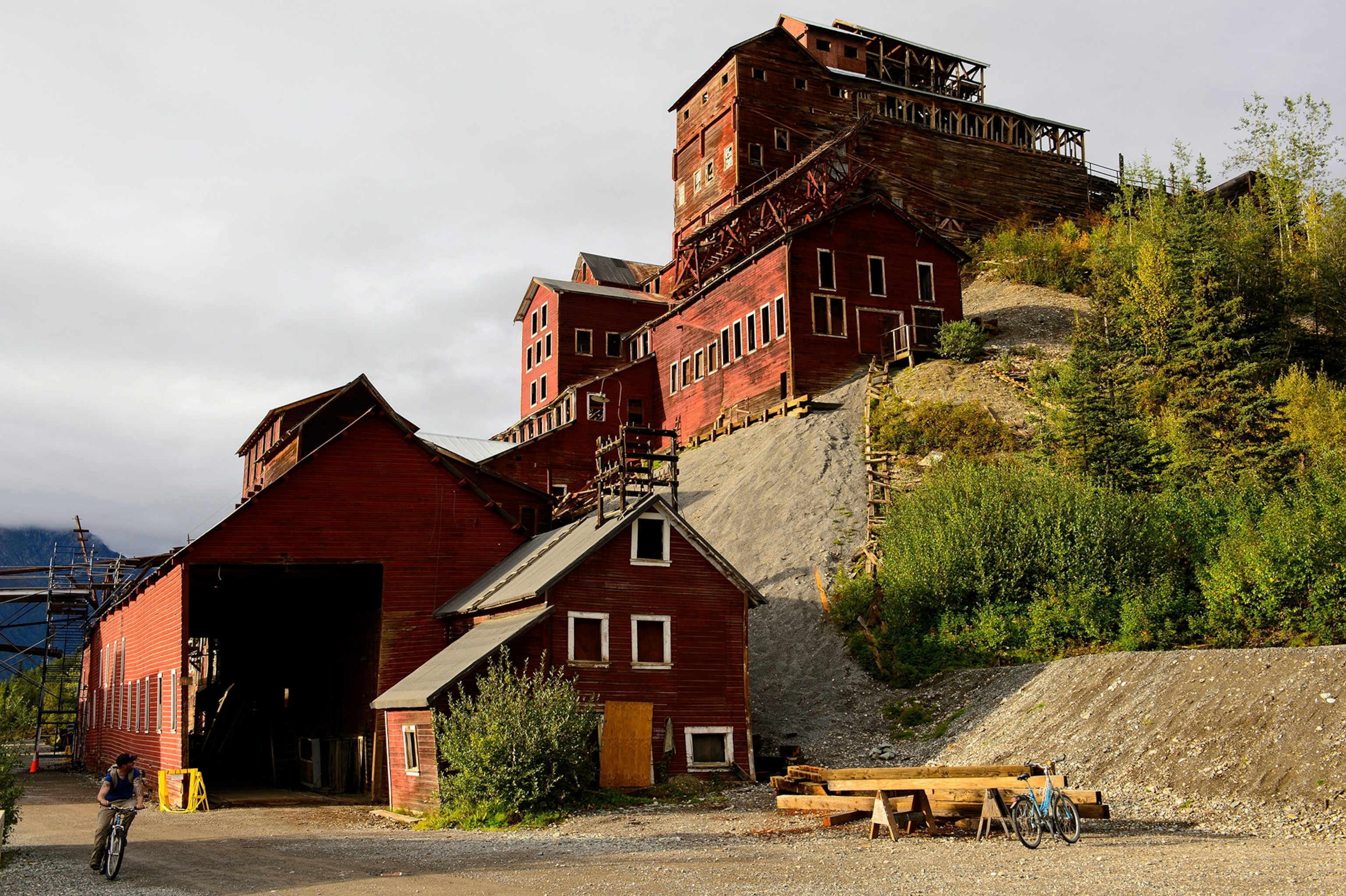 A biker passes The Kennecott Mill in Alaska, USA.