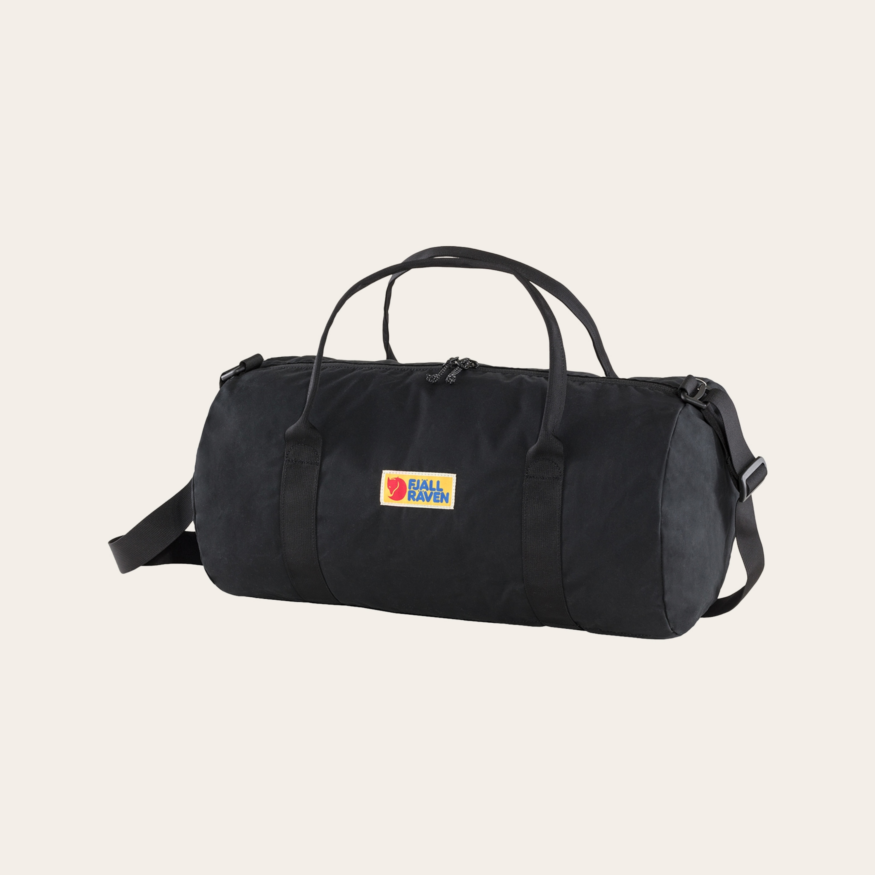 A black duffel bag against a tan background.