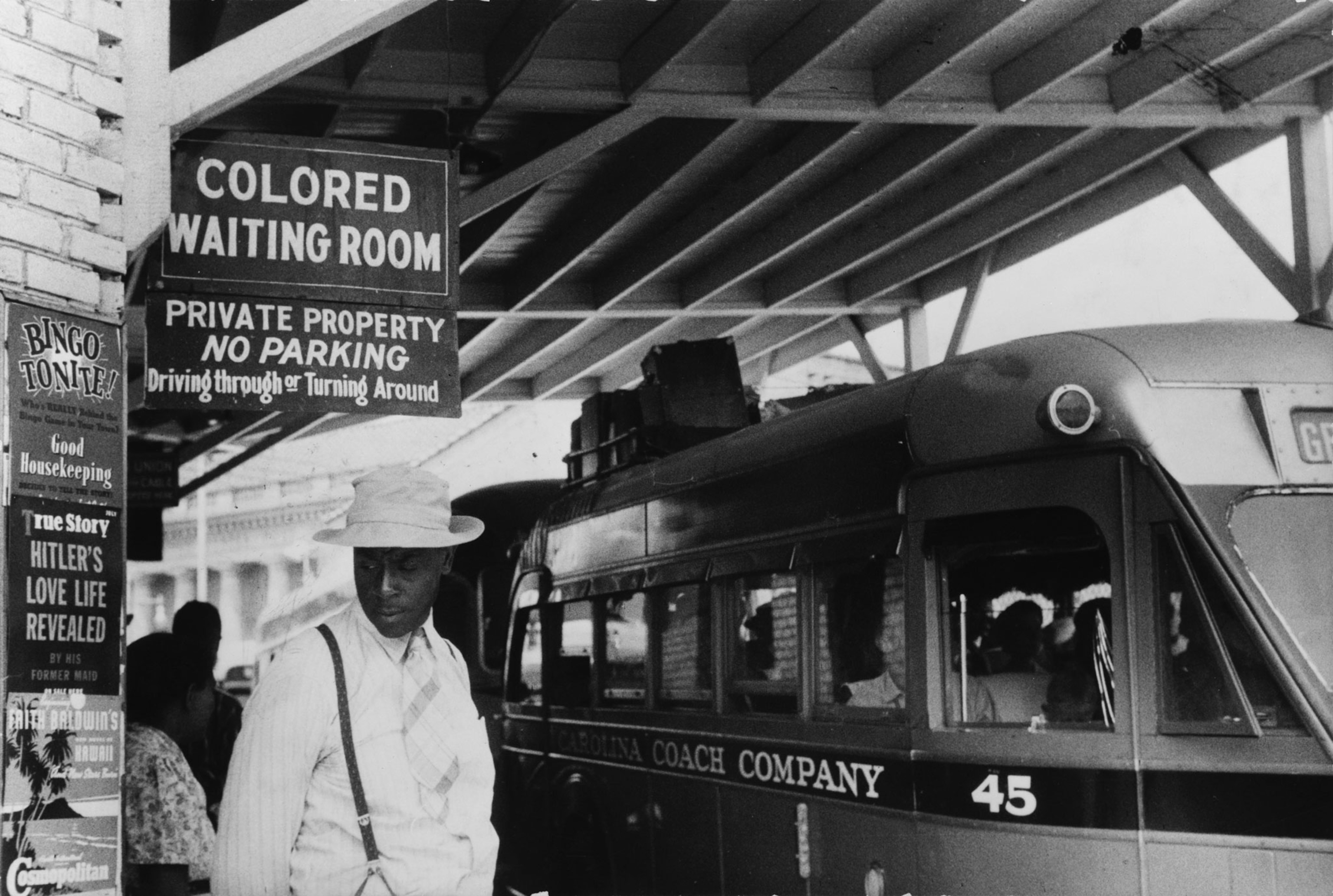 a sign that reads Colored Waiting Room at a bus station