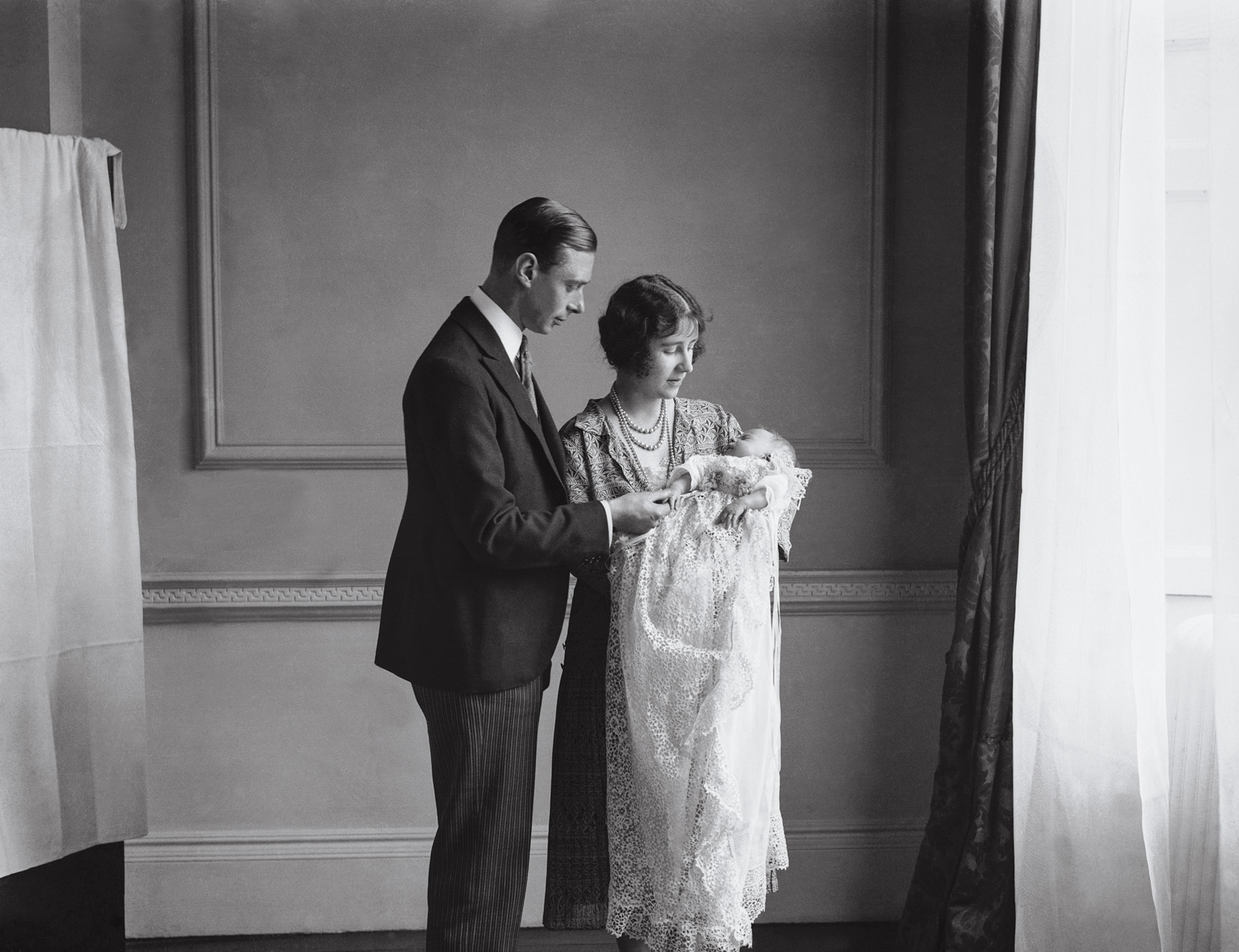 Elizabeth’s parents, “Bertie” and Elizabeth, hold her in 1926 after her christening.
