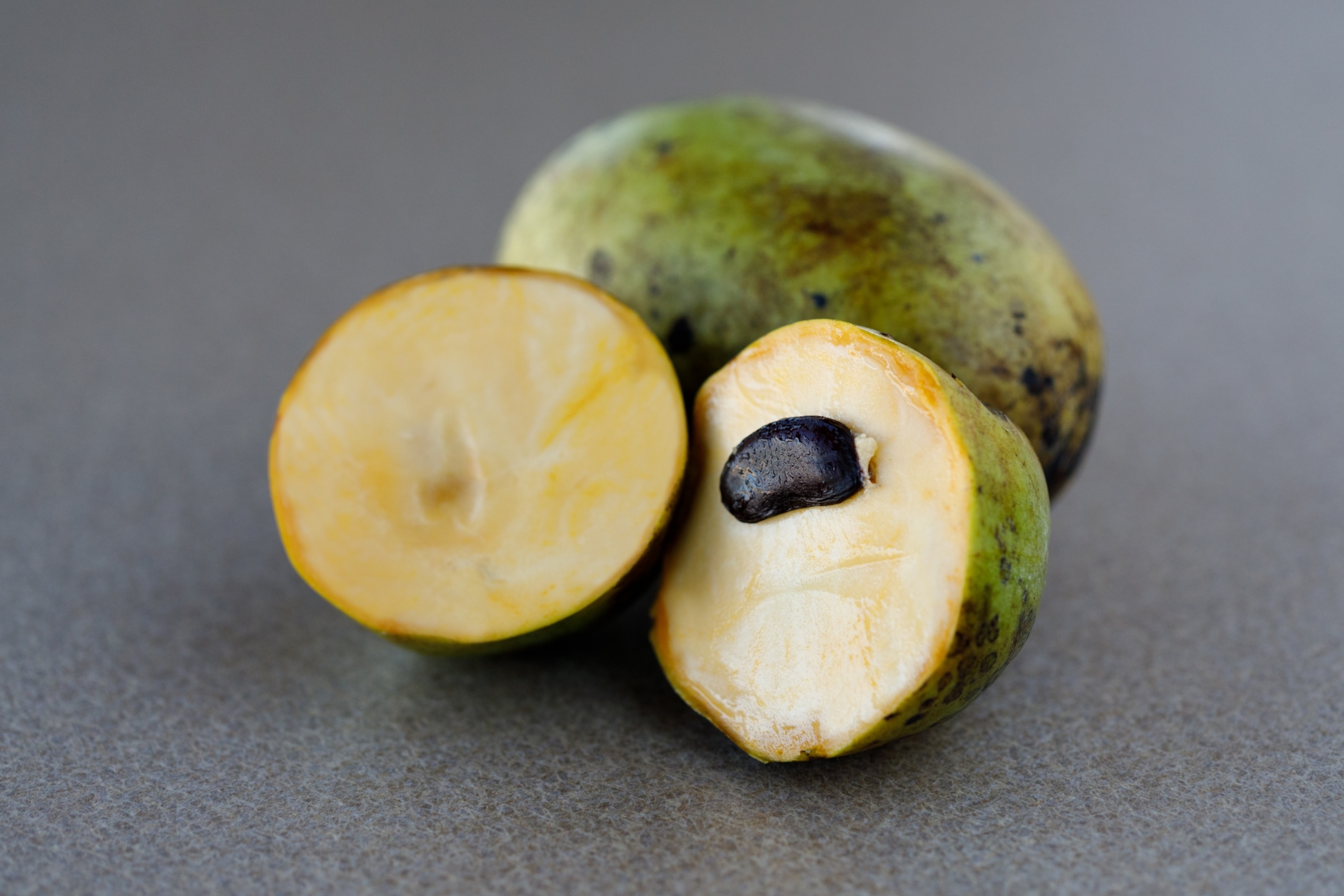 Green fruit cut in the middle revealing