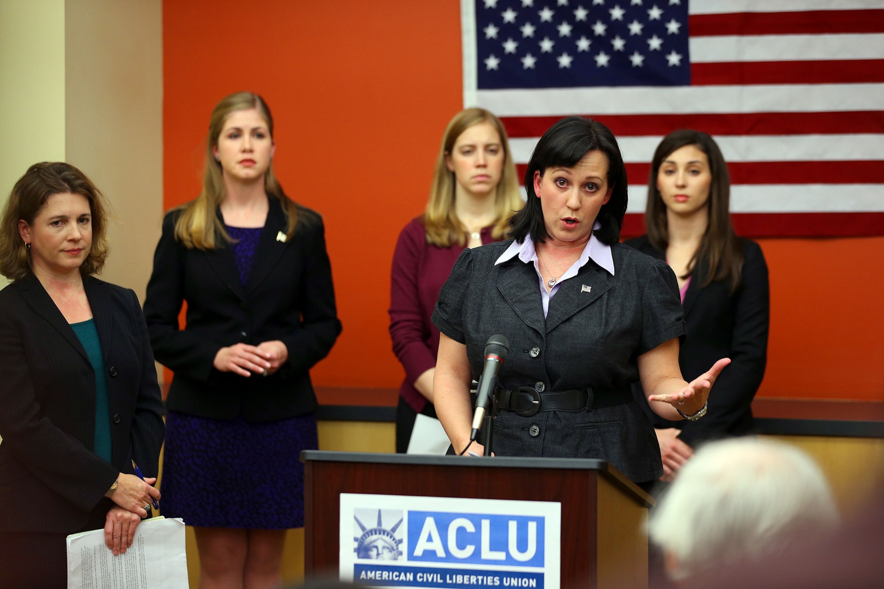 a woman speaking at a conference
