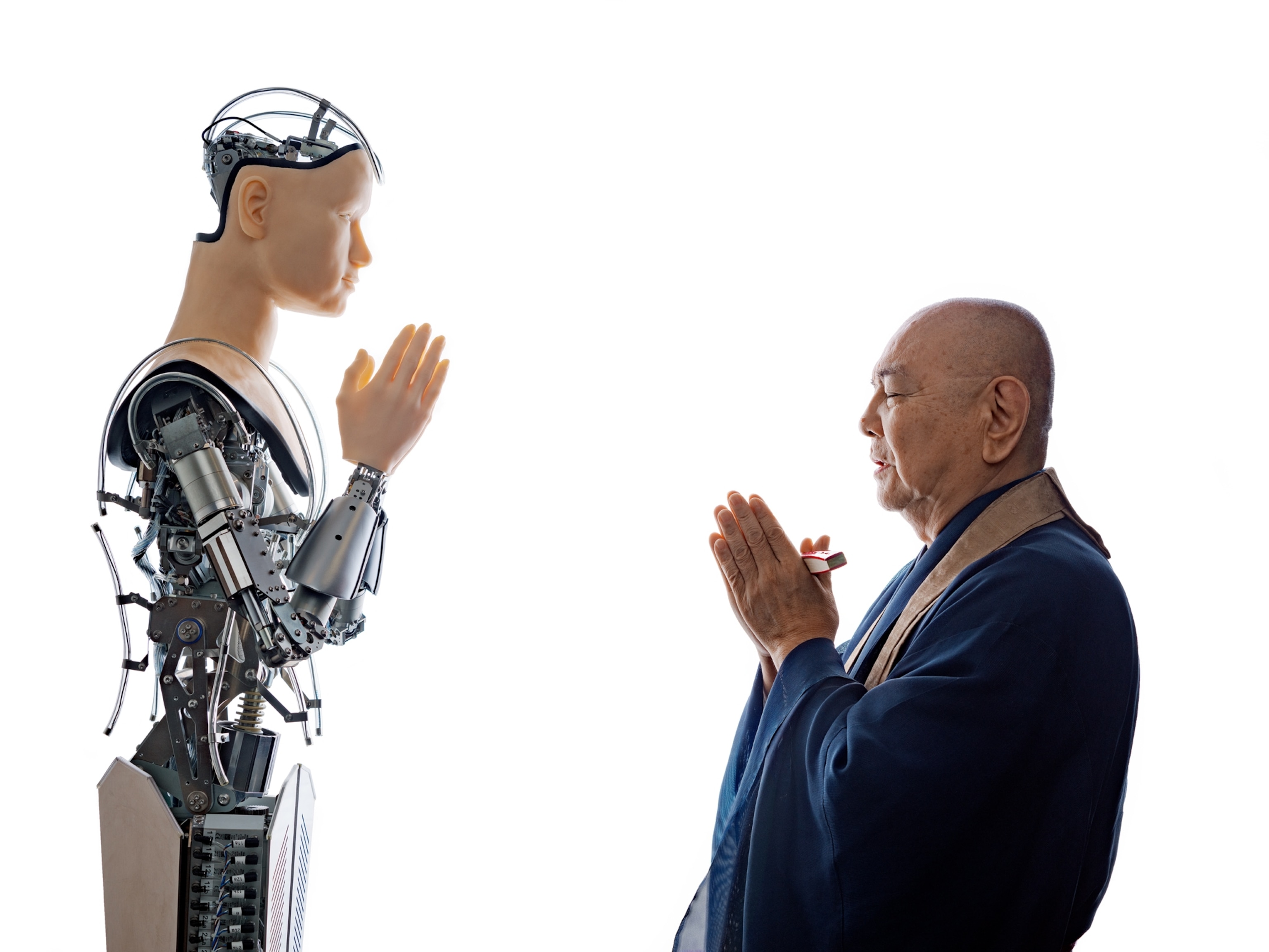 robot with human face and monk praying together.