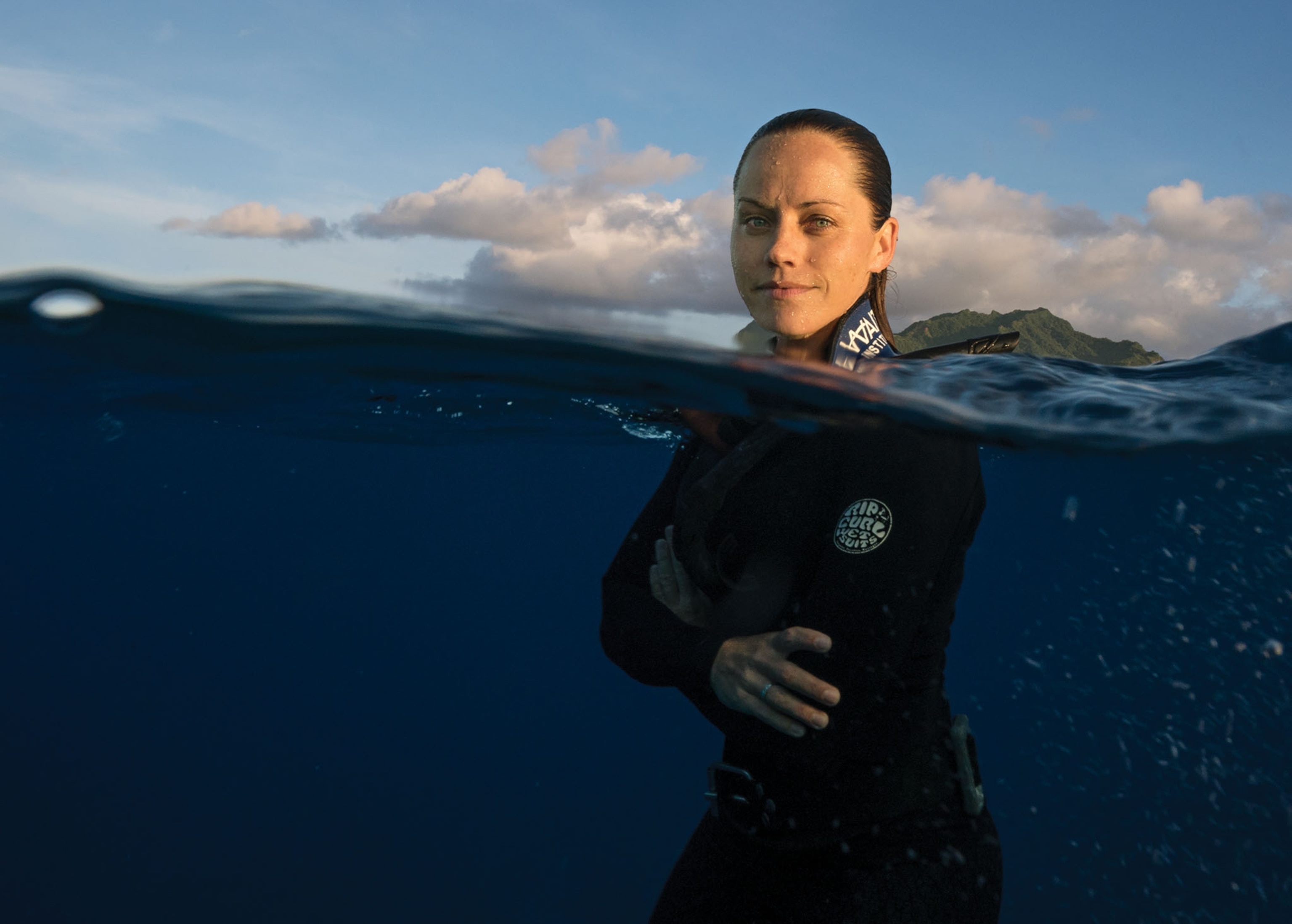 jess cramp in a wetsuit half submerged in the water