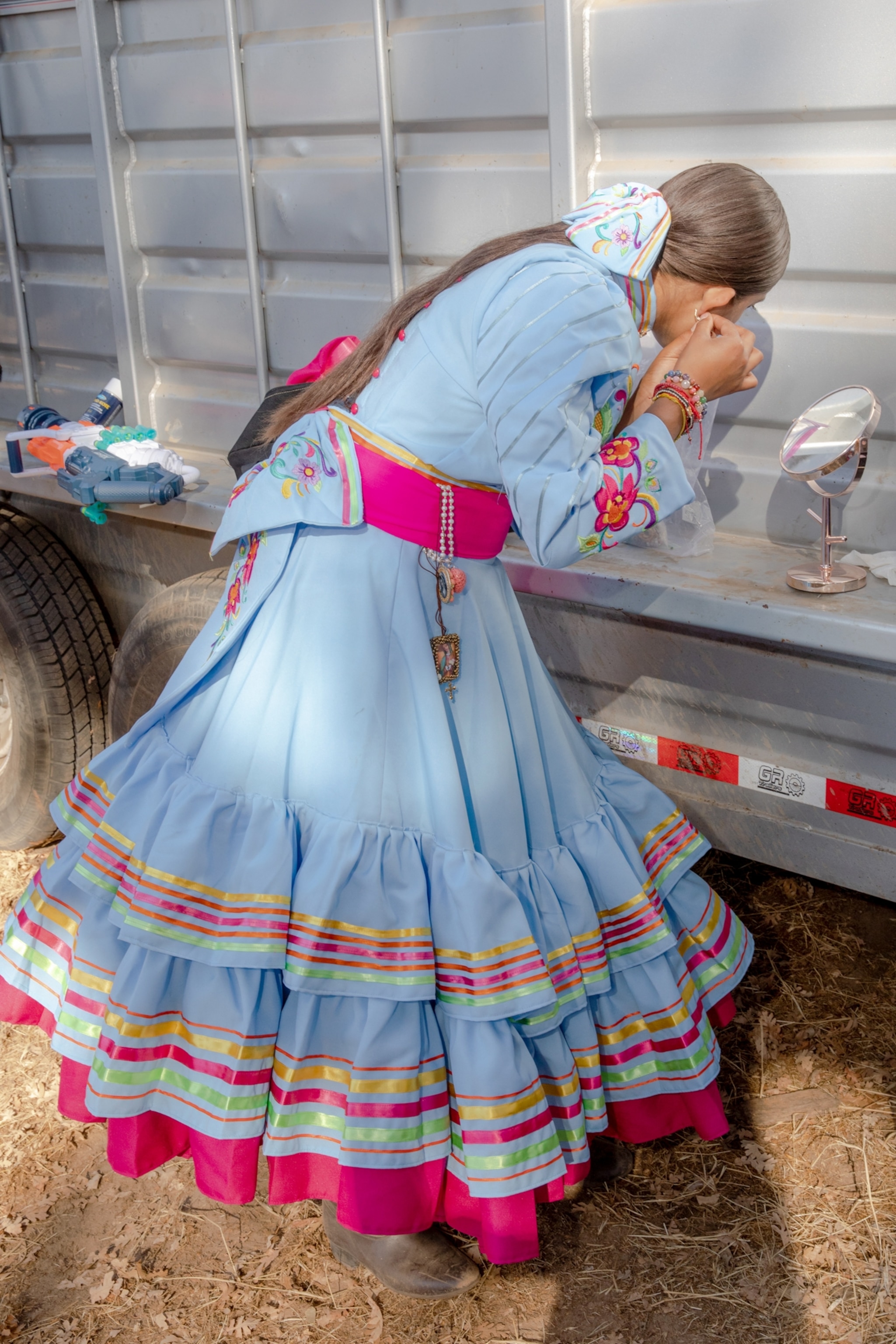 a woman gets ready for a rodeo competition