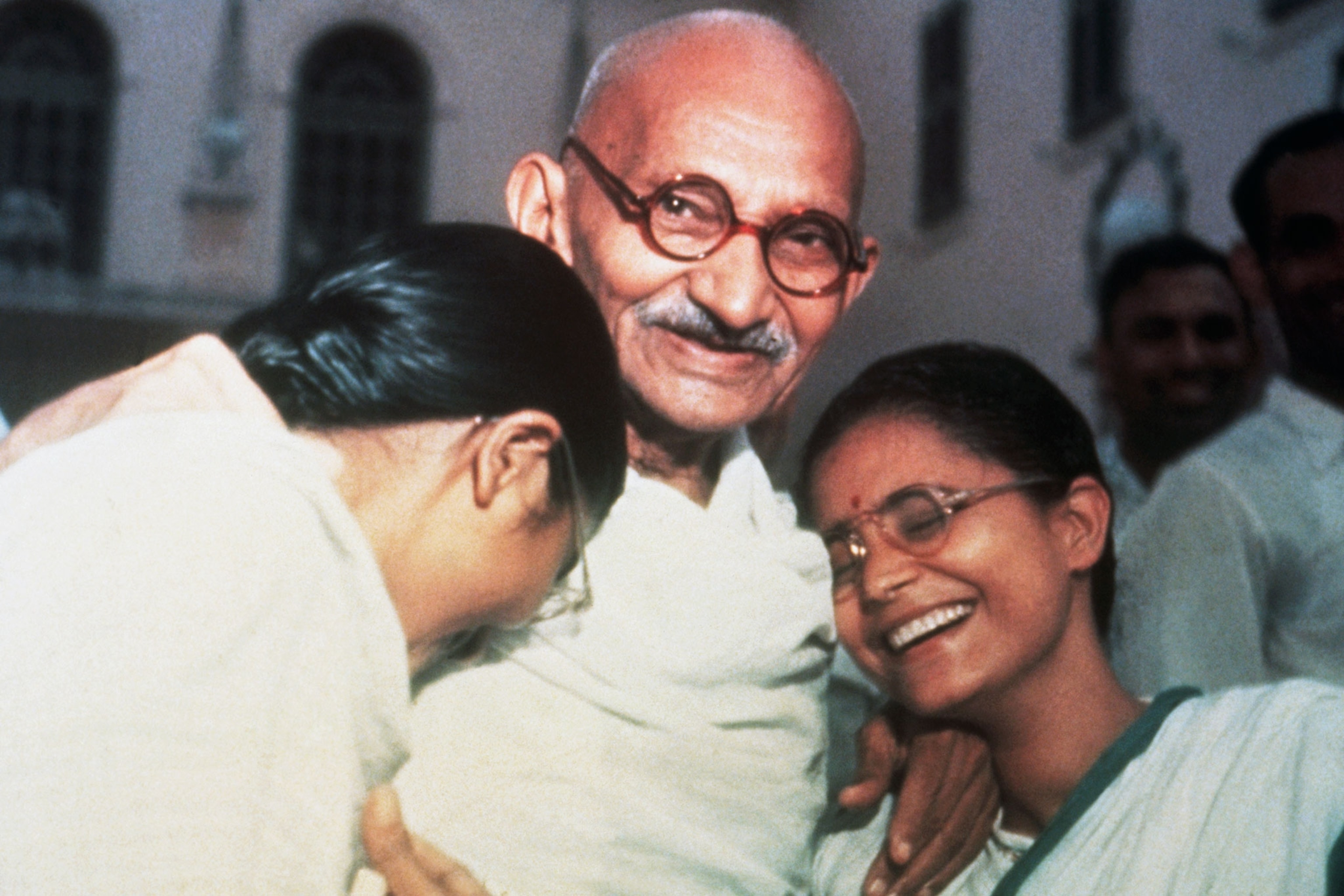 Mahatma Ghandi with two granddaughters