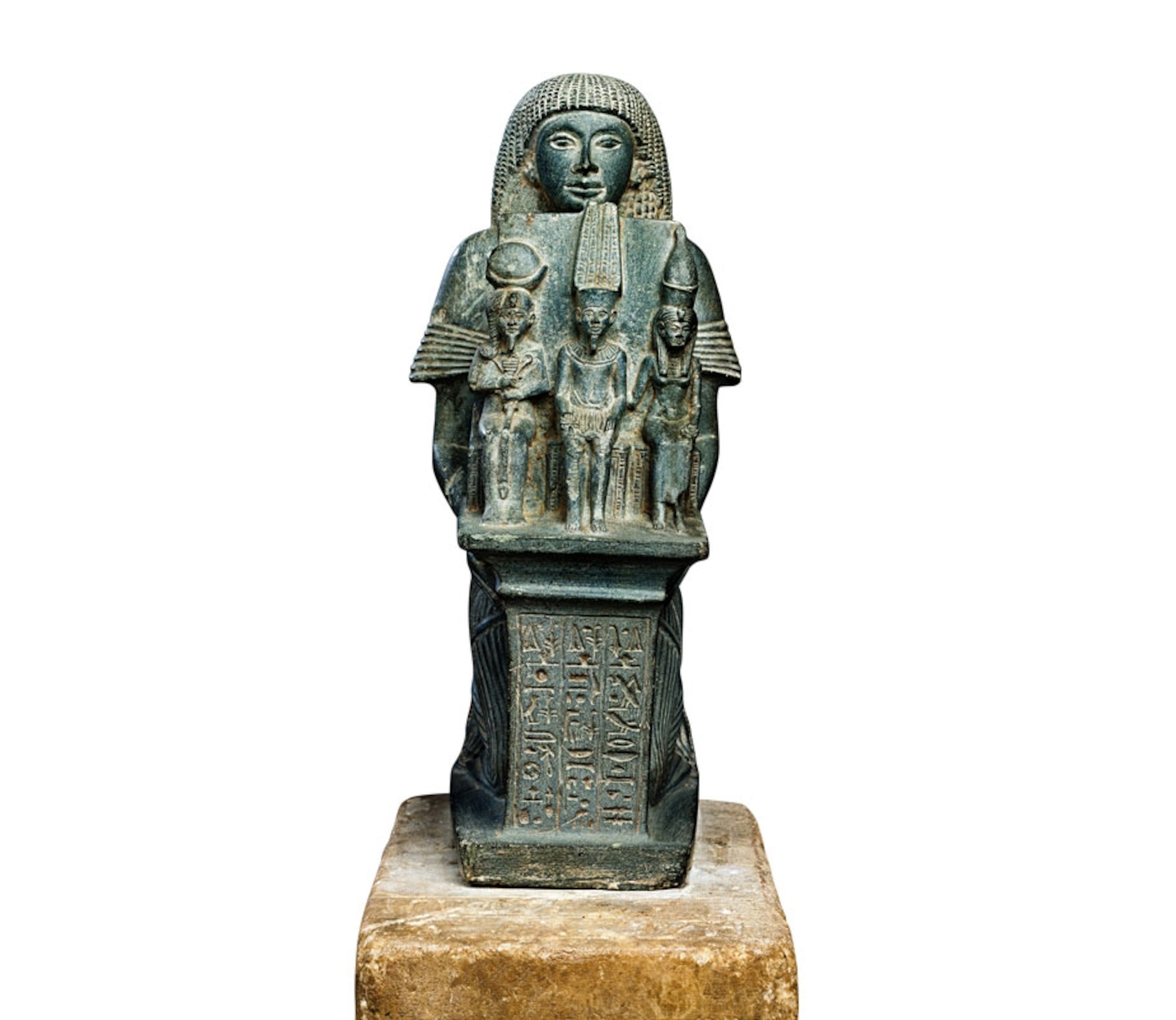 a statue of a high priest of Thebes holding figures of Amun, Mut, and Khons