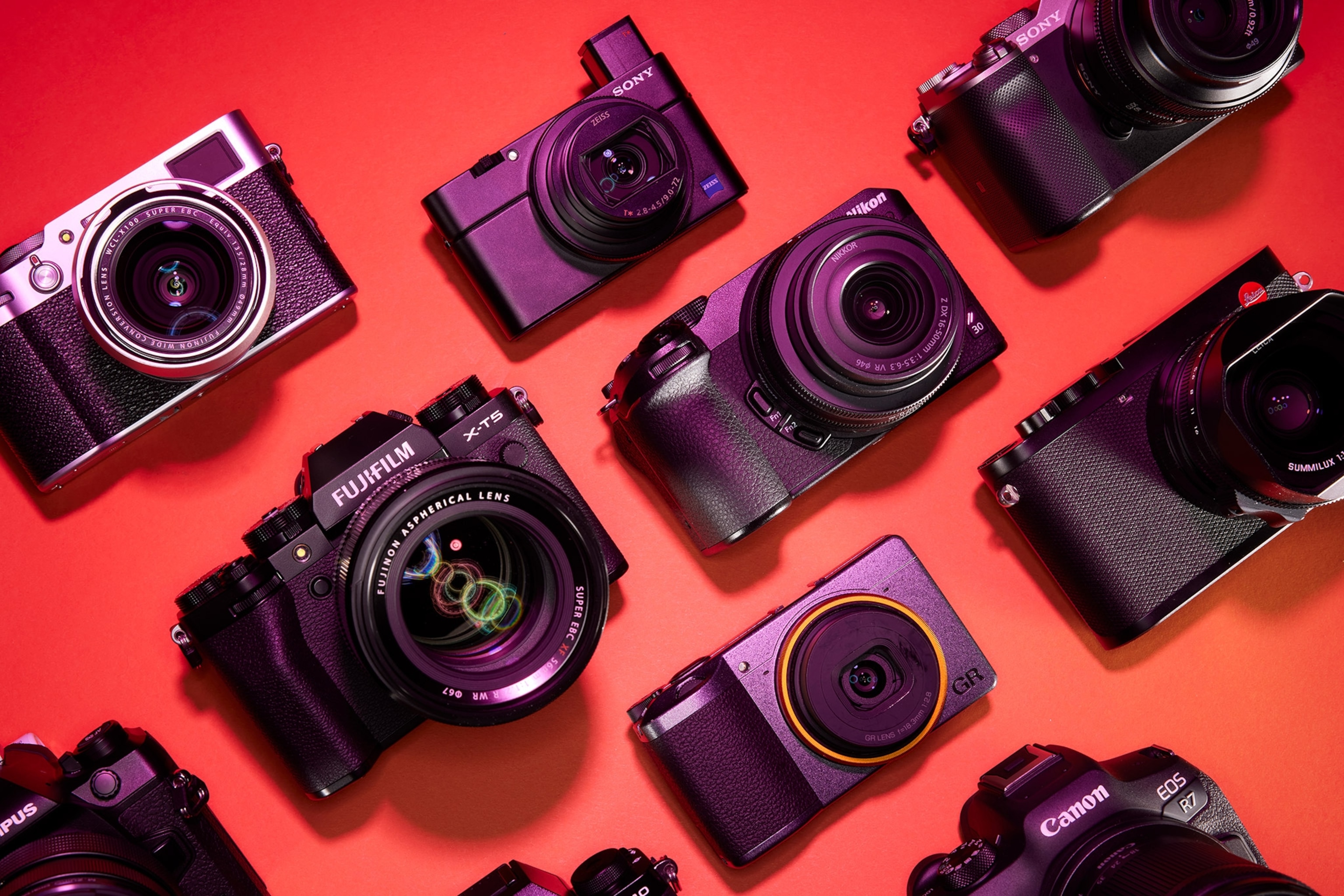 Studio photograph of a collection of cameras for the National Geographic 2023 travel camera guide
