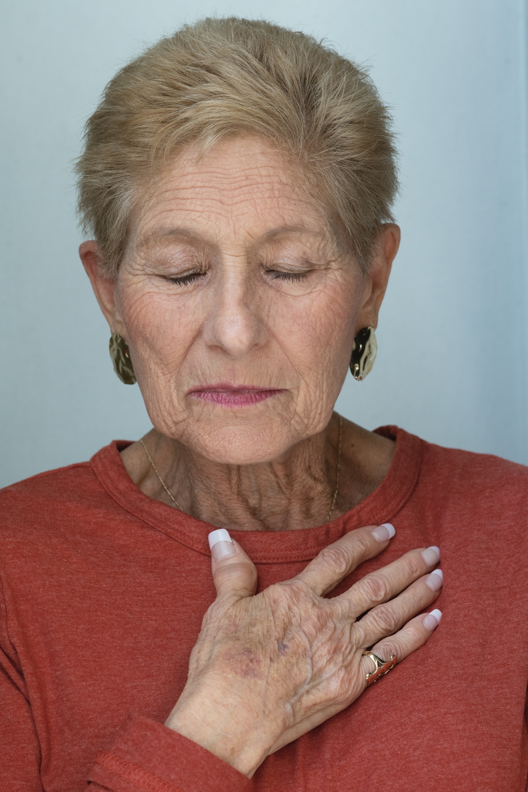 a woman with her eyes closed tenderly standing for portrait