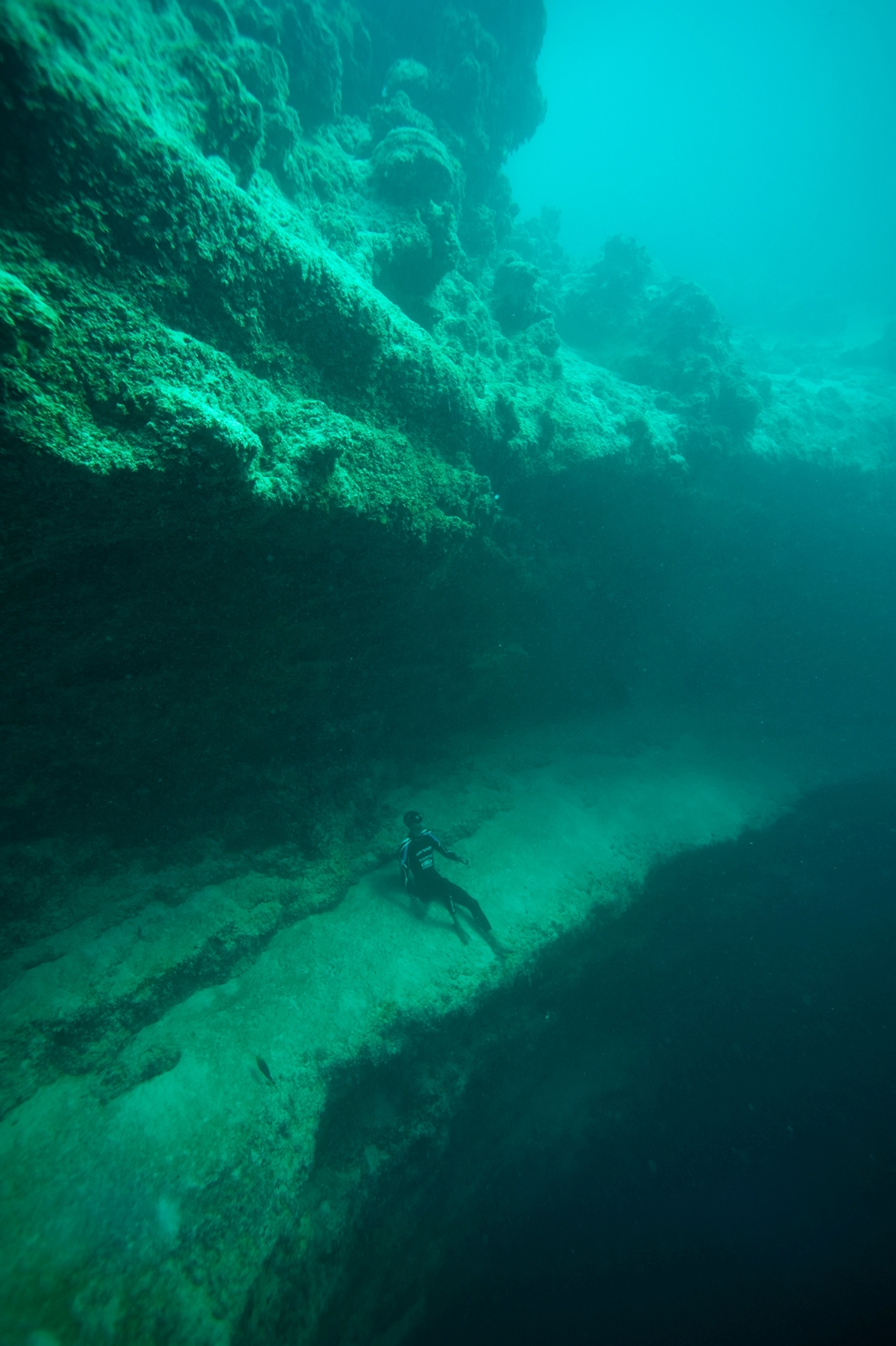 a diver resting on the edge of Dean's Blue Hole