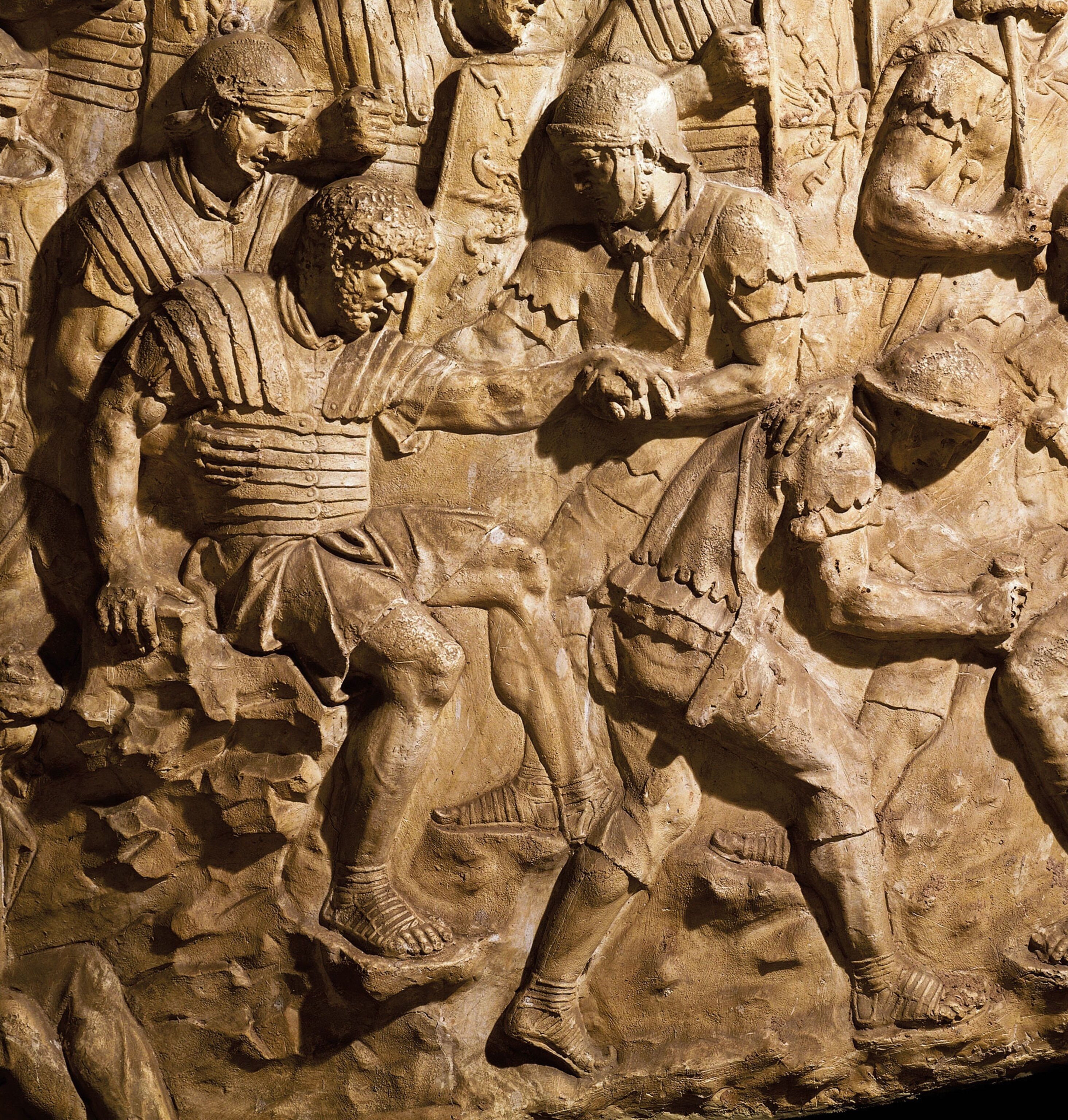 a stone relief of men fighting