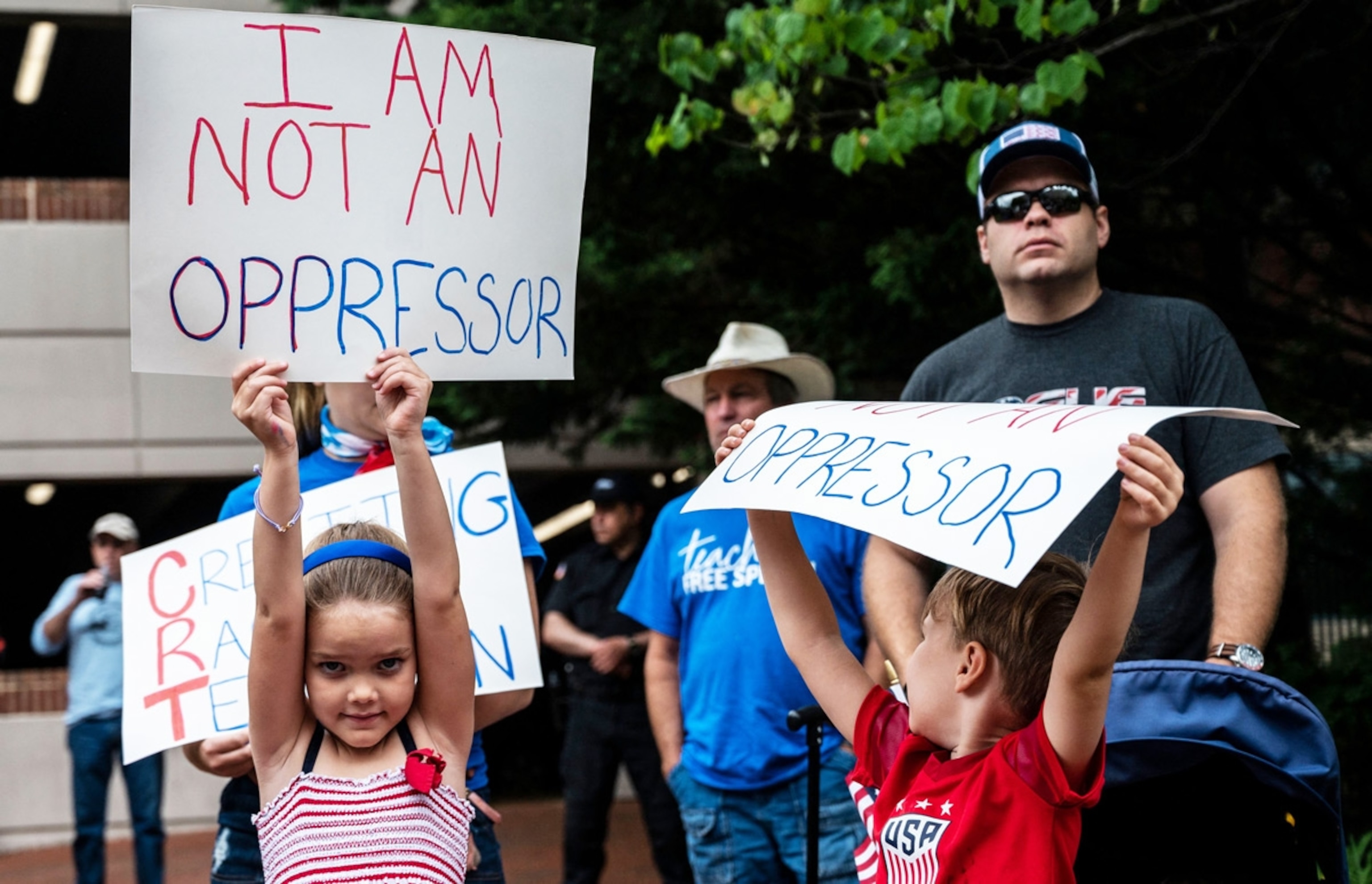 A girl holds up a sign at a June 12 rally in Leesburg, Virginia, protesting the teaching of what some call "critical race theory" in schools.