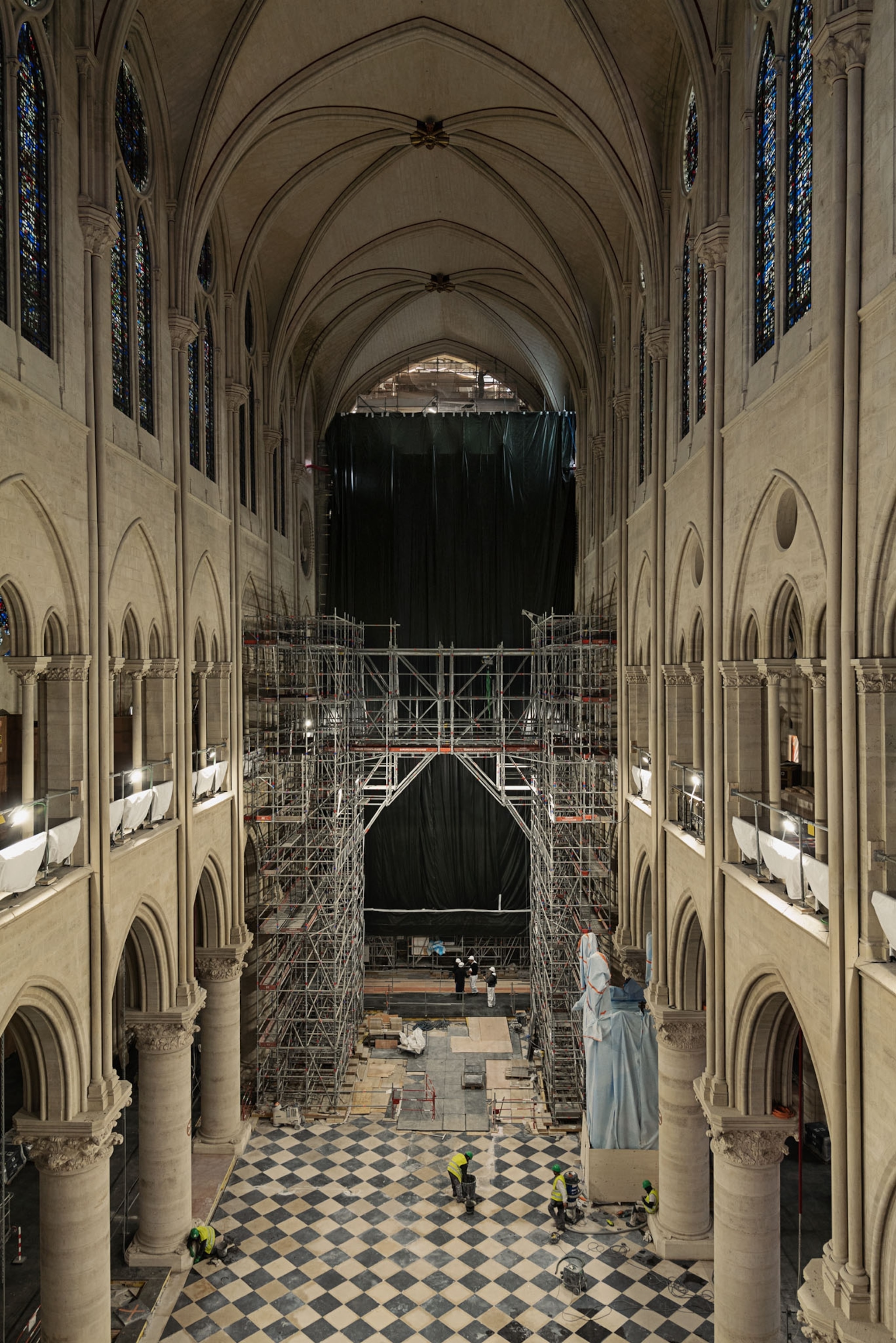 Photograph of the nave of the Notre Dame Cathedral of Paris shot on the second floor.