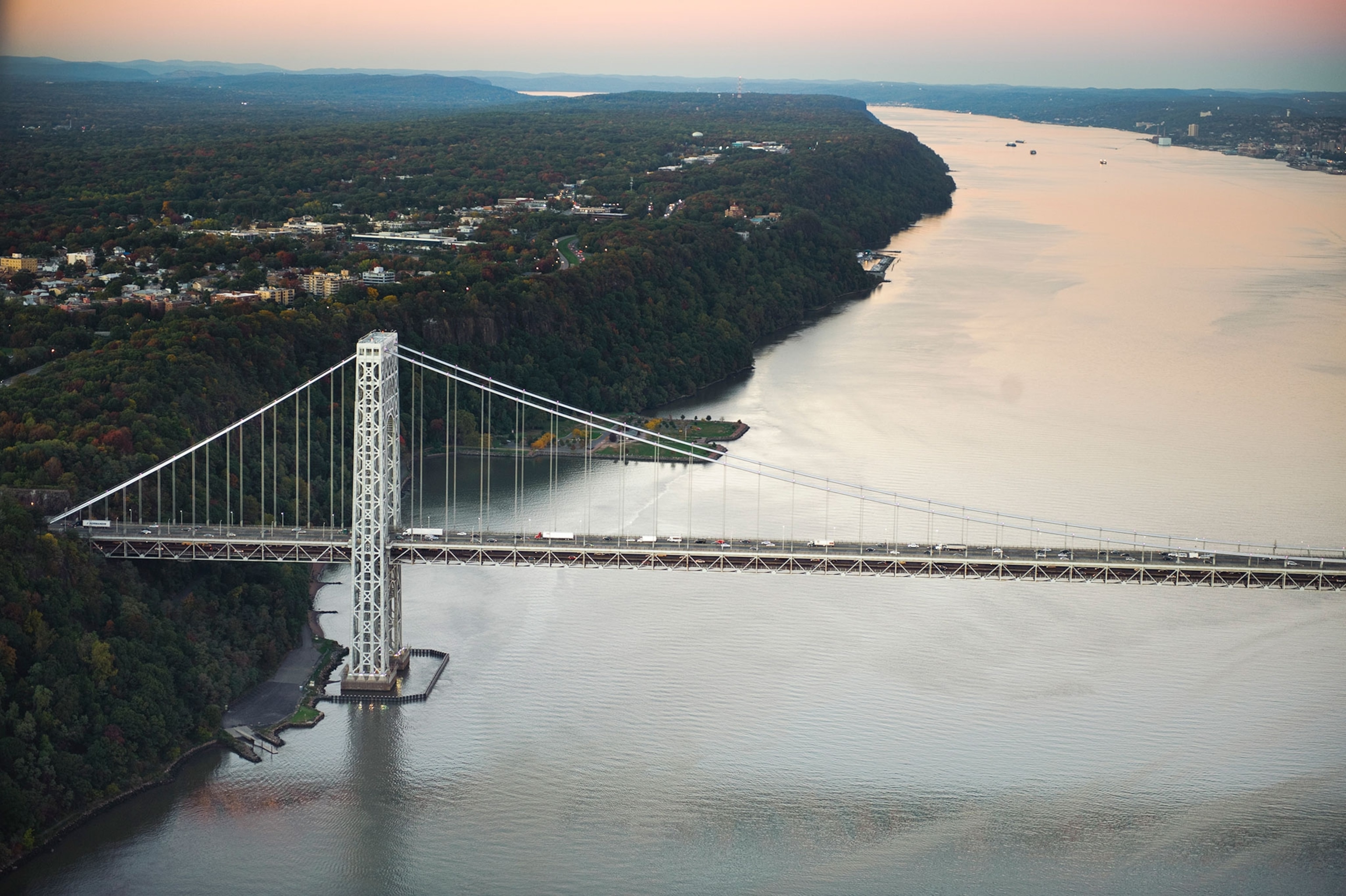 the hudson river and the george washington bridge at sunset