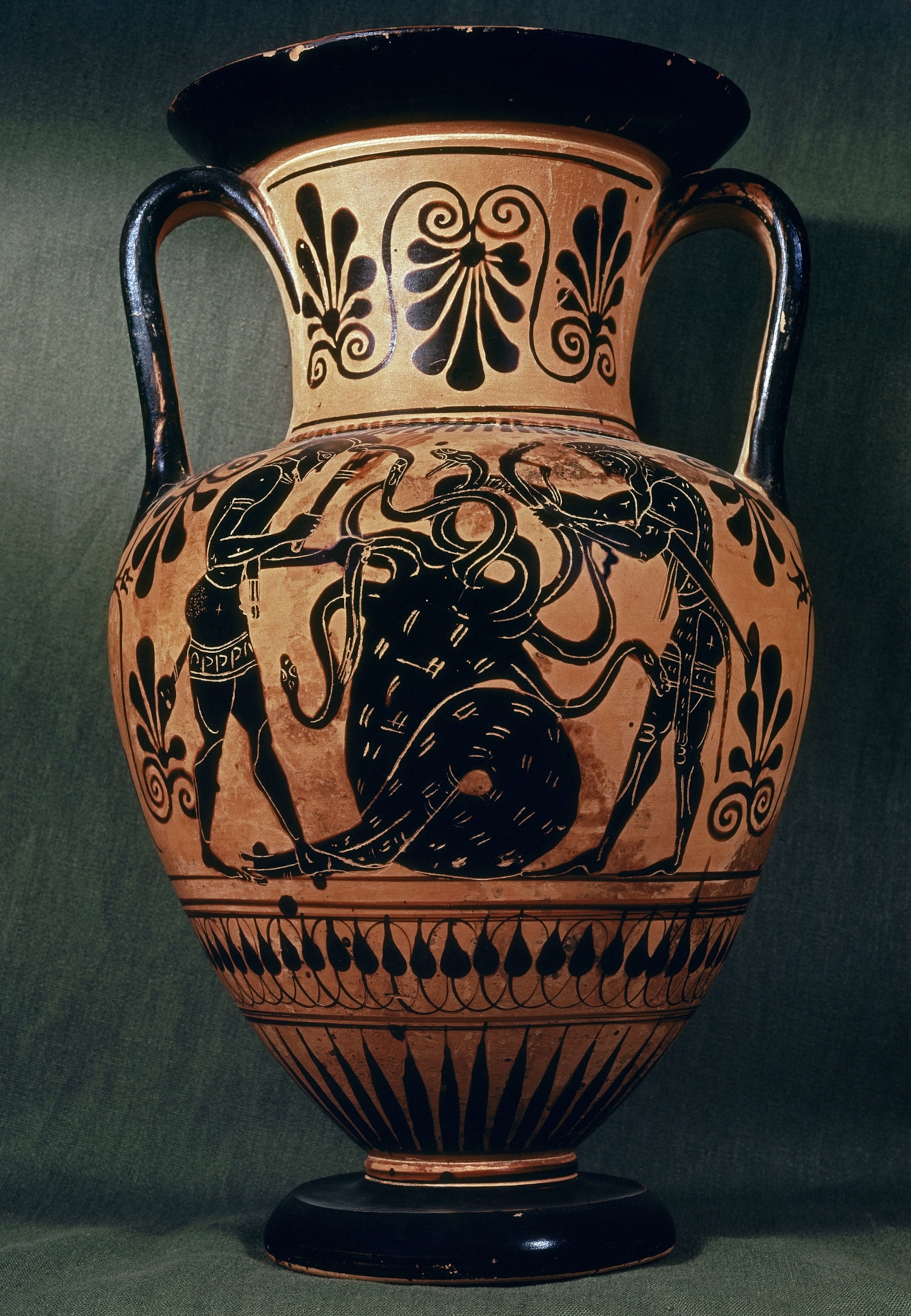 A tall ceramic amphora decorated with black figures cutting the heads off a hydra.