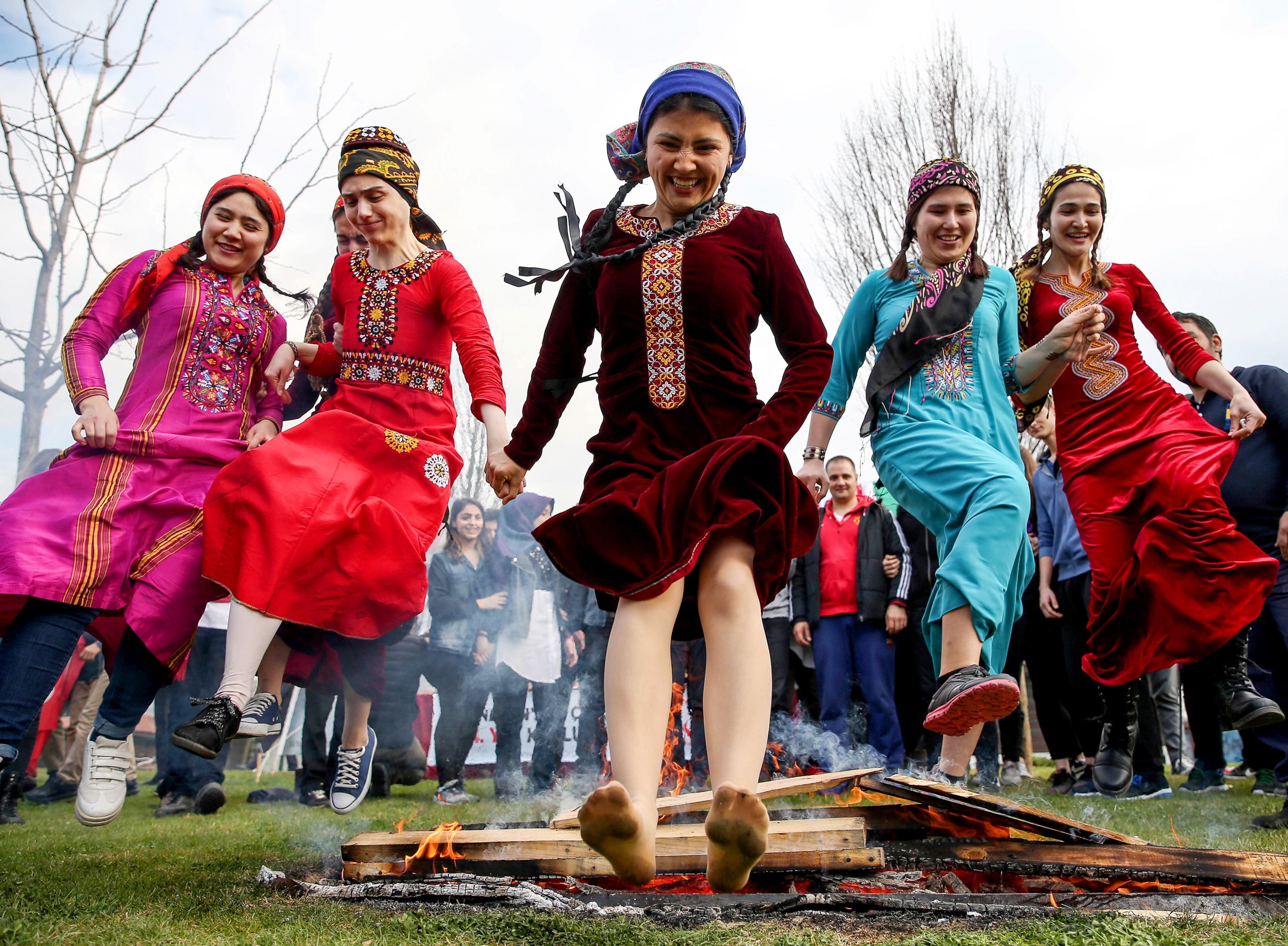 women jumping over a fire during Persian New Year celebrations in Istanbul, Turkey