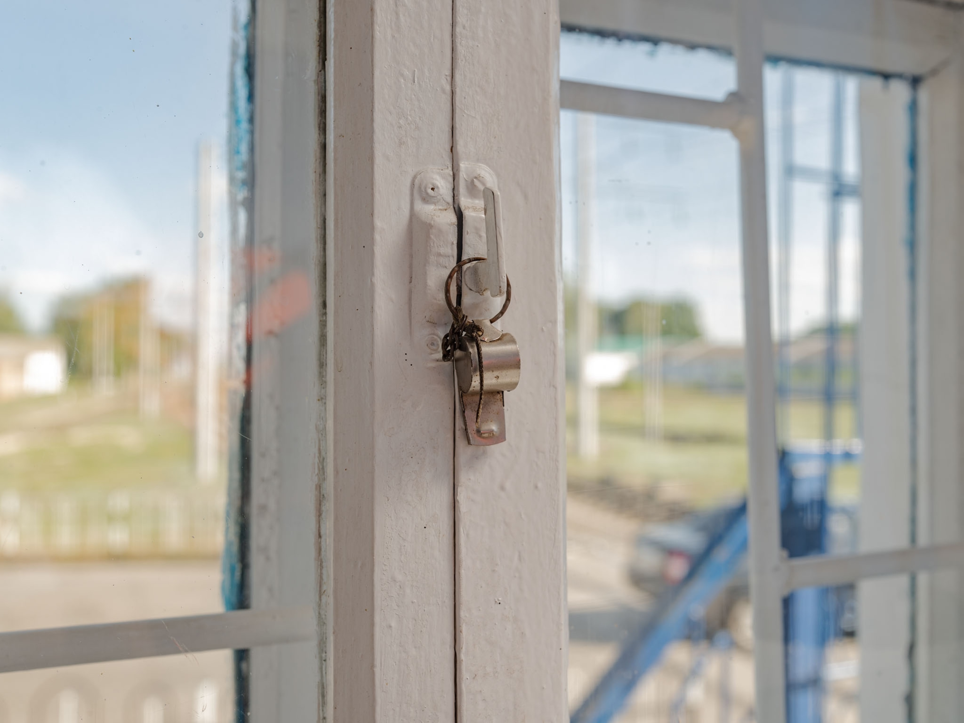metal whistle hanging on window handle.
