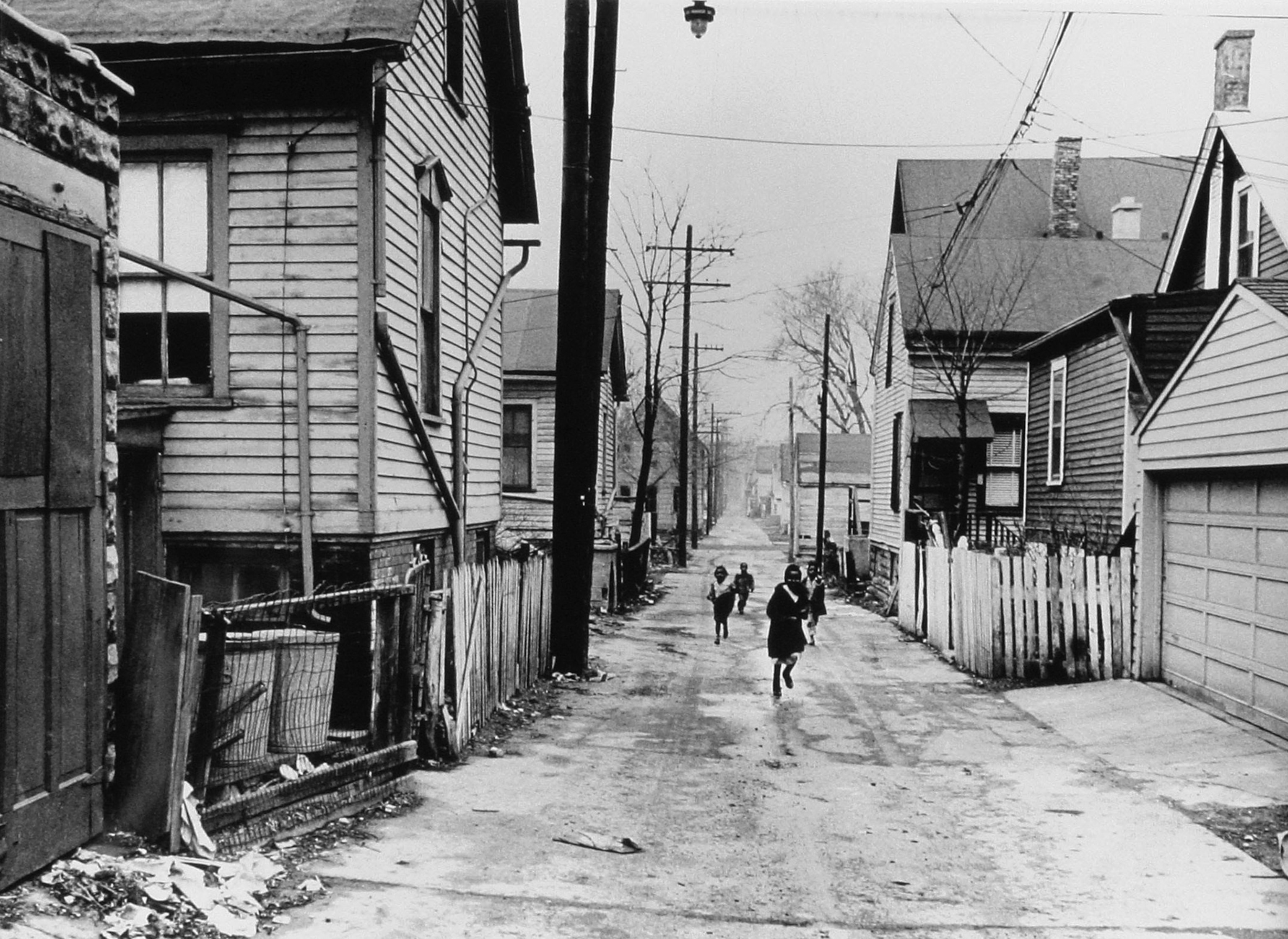 Children playing in black and white photograph.