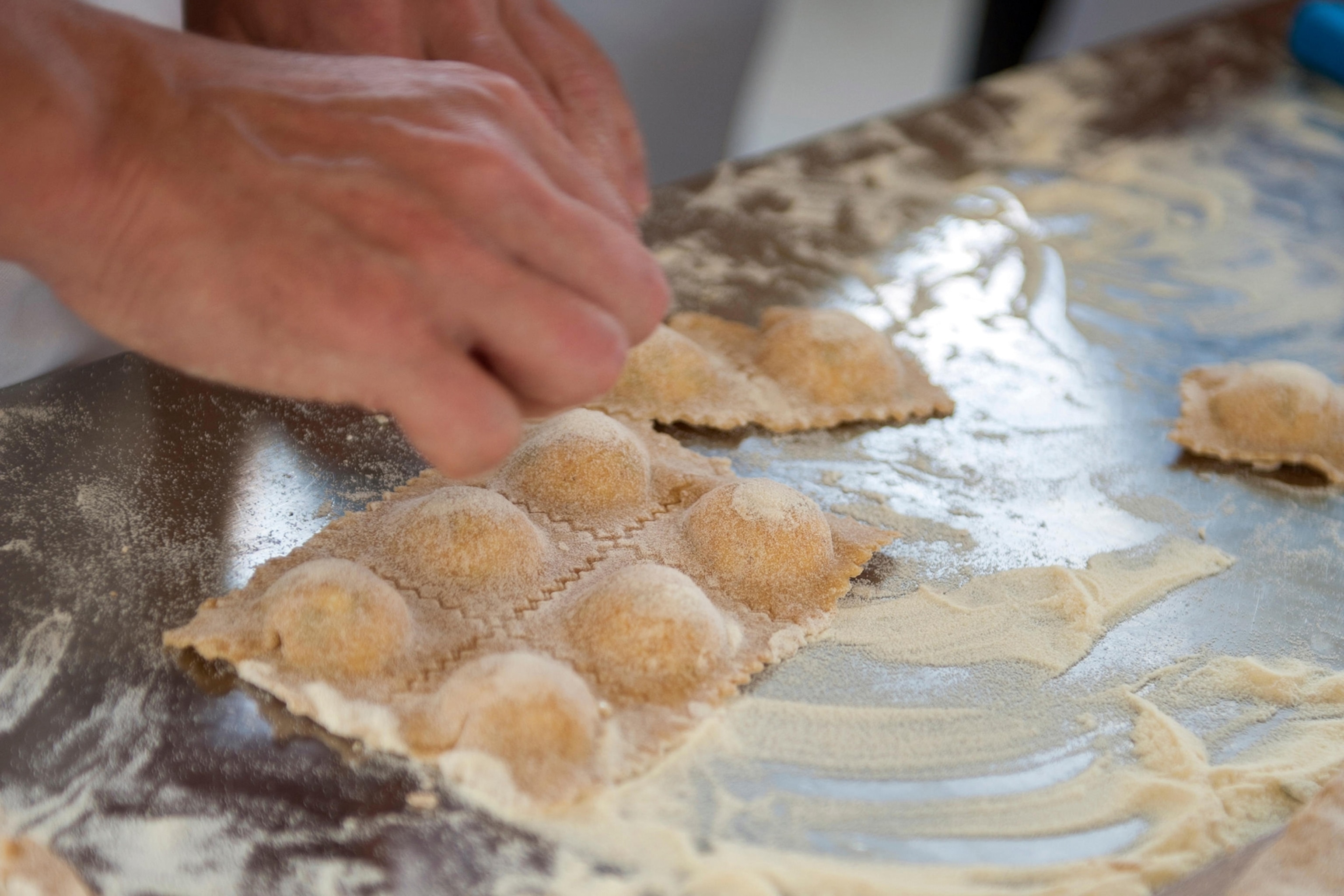 Shot of hands making ravioli.