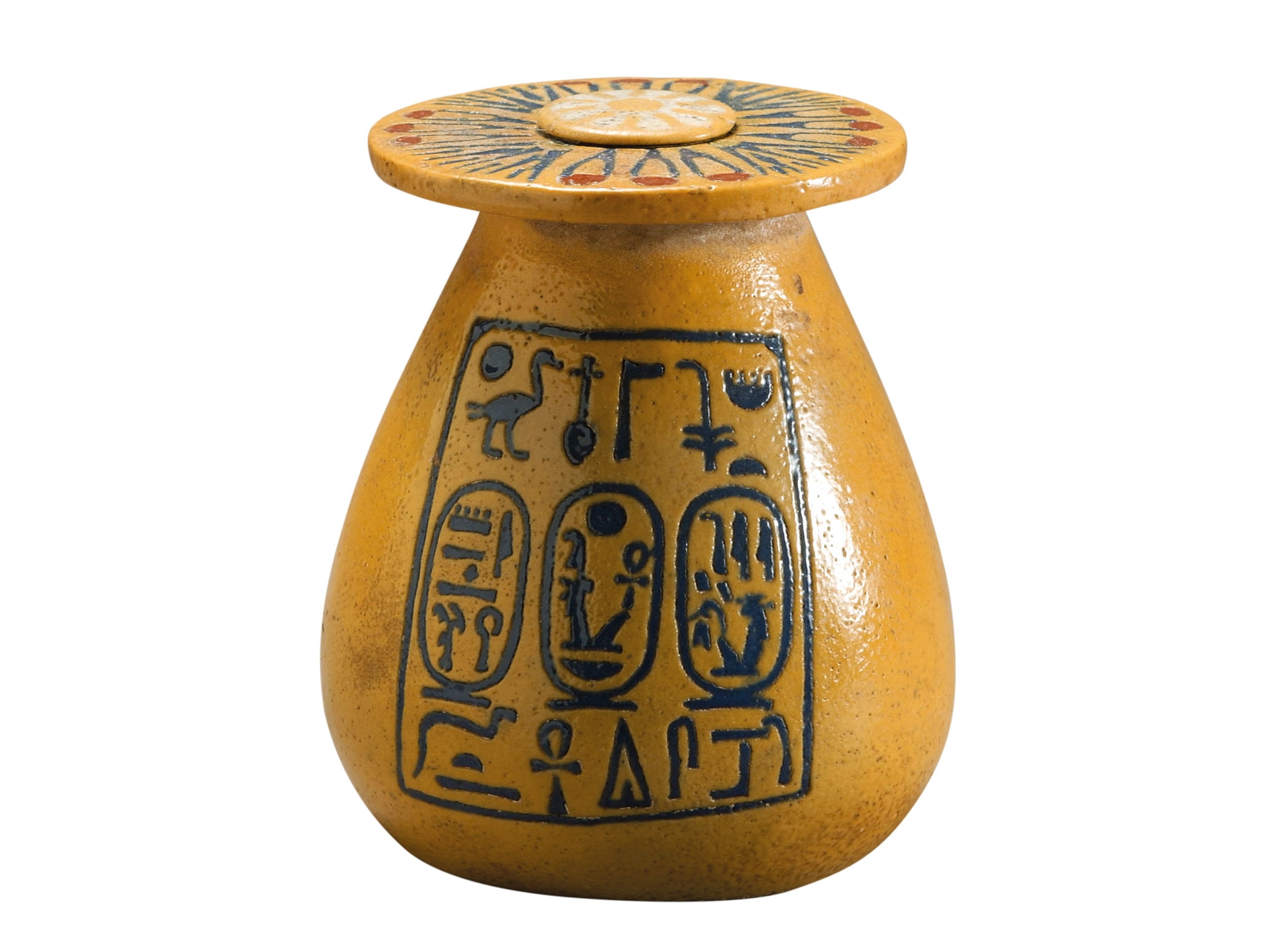A small mustard colored jar with hieroglyphs on it