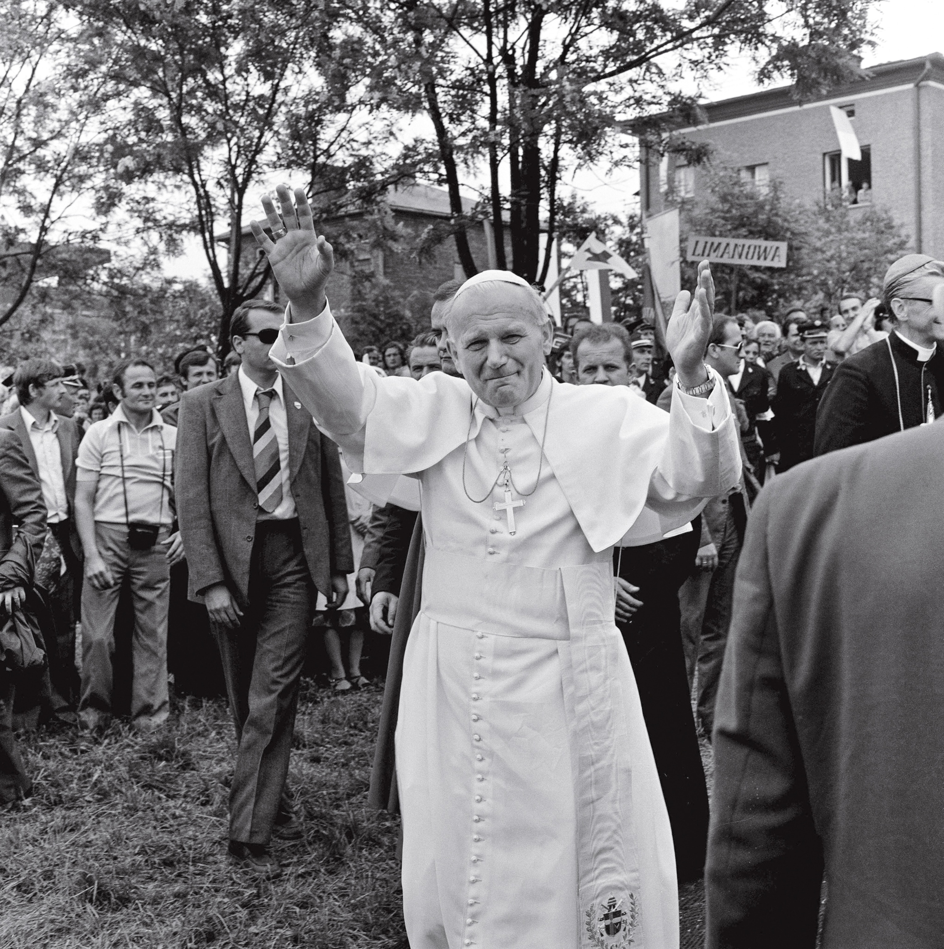 the pope waving with both hands in the air