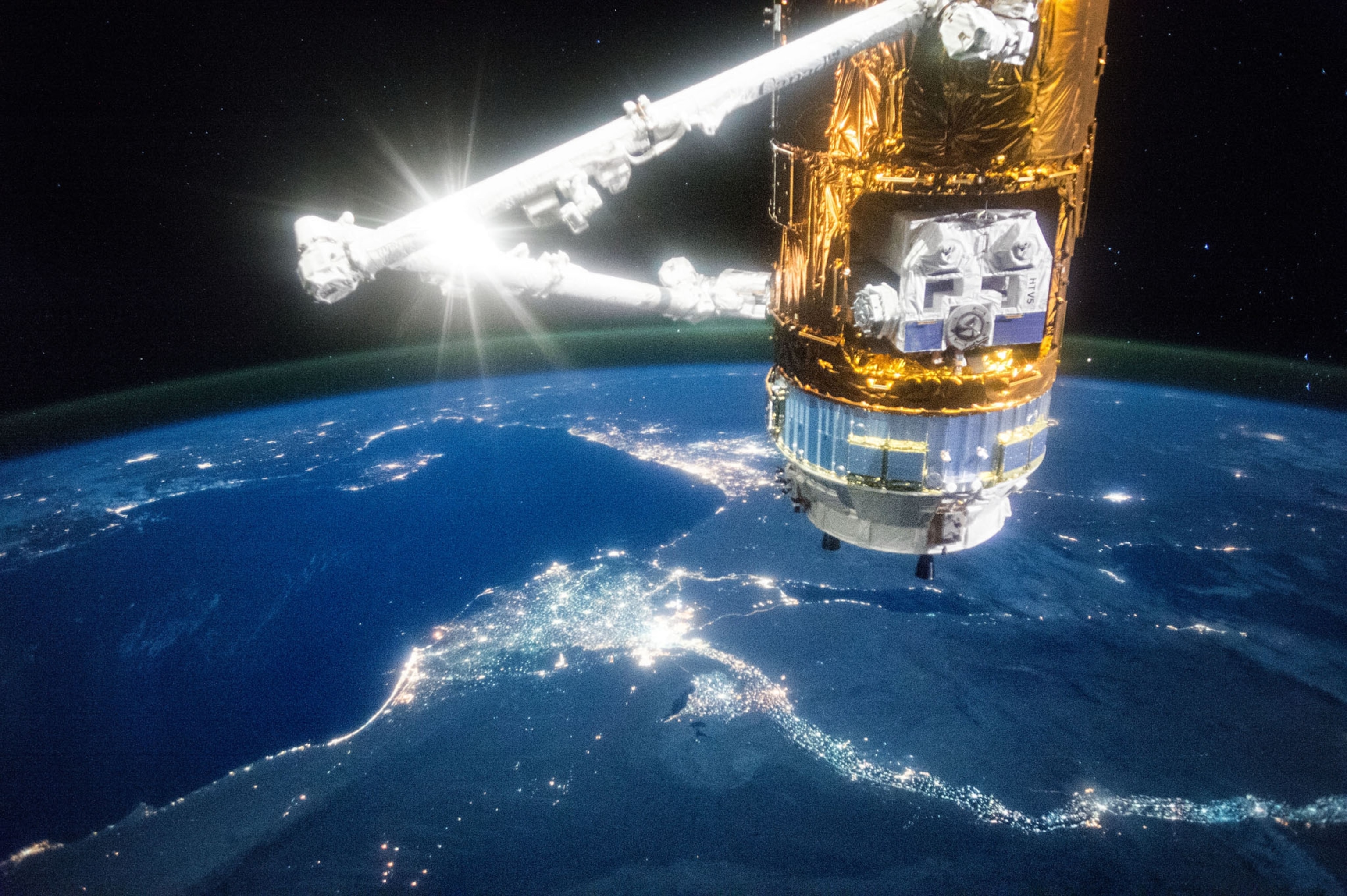 a spacecraft above the blue of planet earth