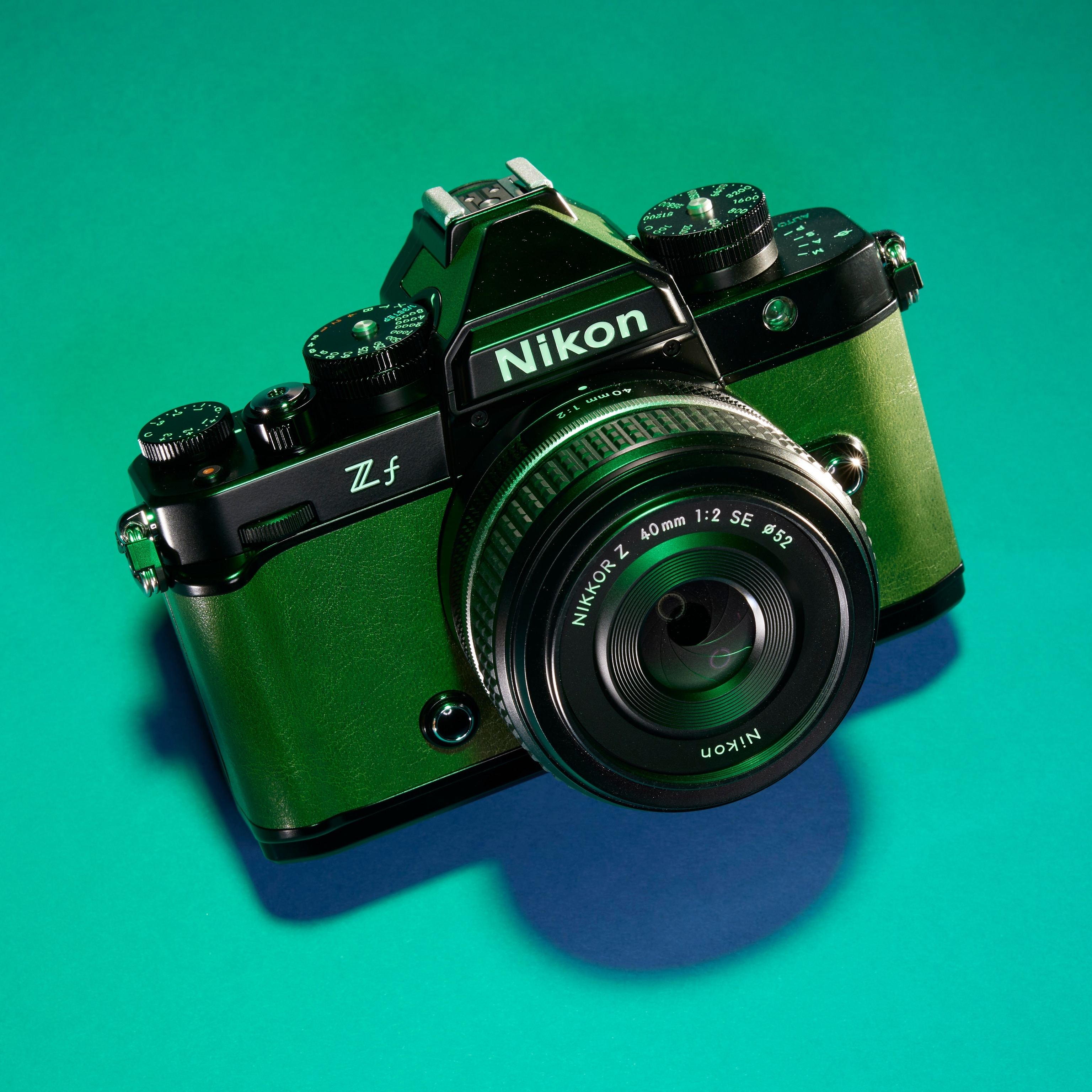 Studio photograph of a Nikon ZF camera against a green background