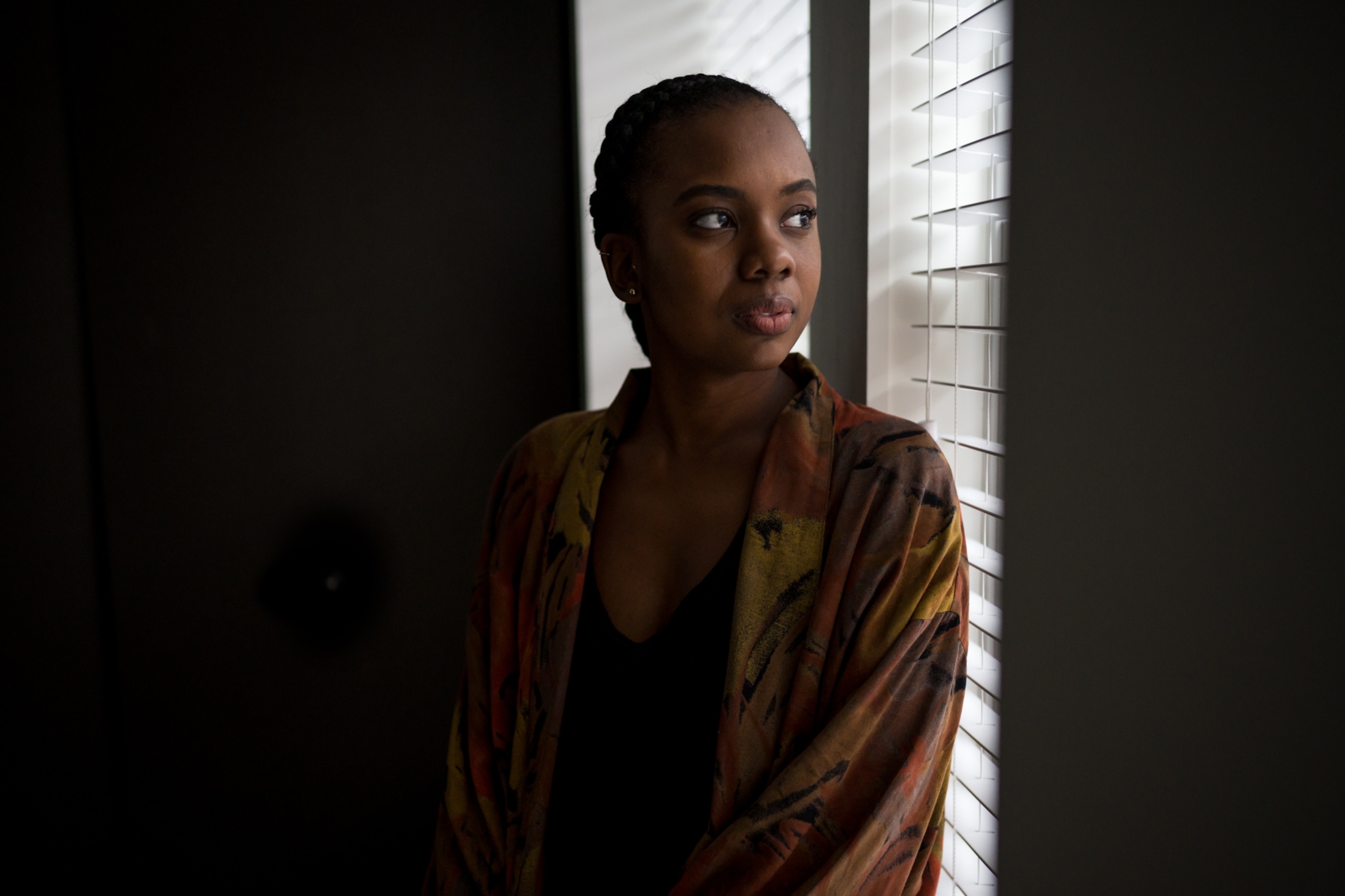 a young woman posing for a portrait by a window