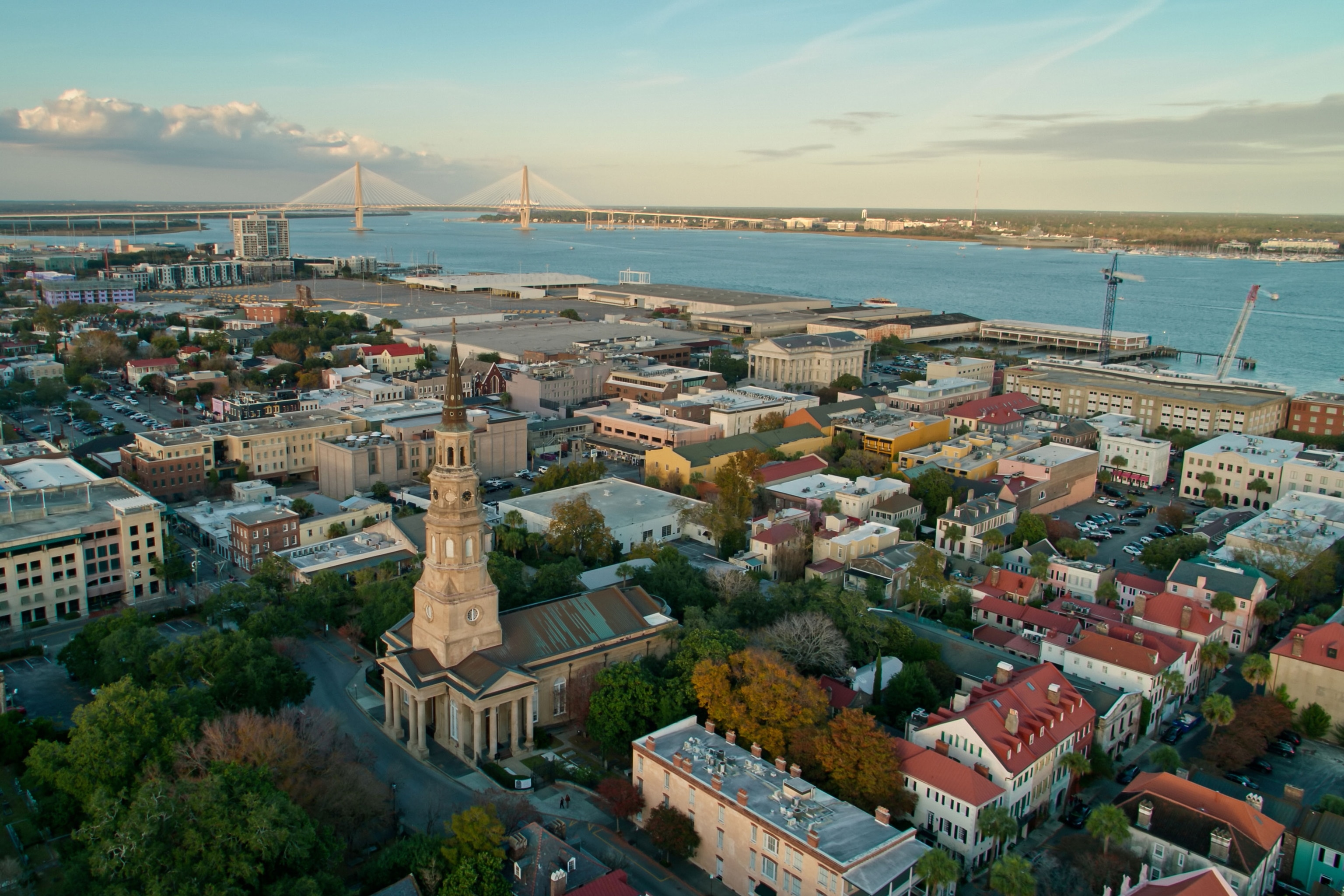 Aerial establishing shot of Charleston, South Carolina at sunset, looking towards the Cooper River Bridge.