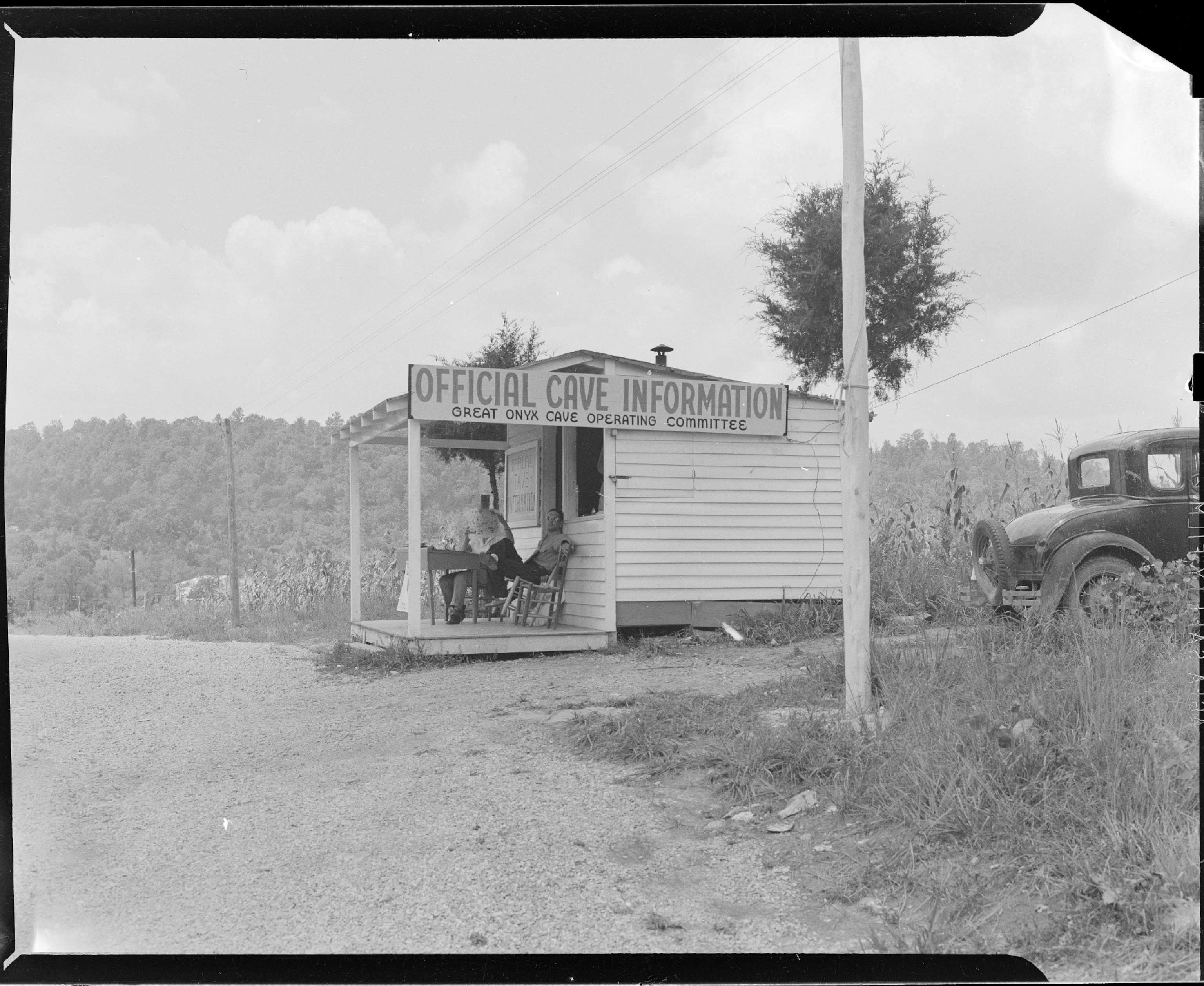 a white wooden shack on the side of the road