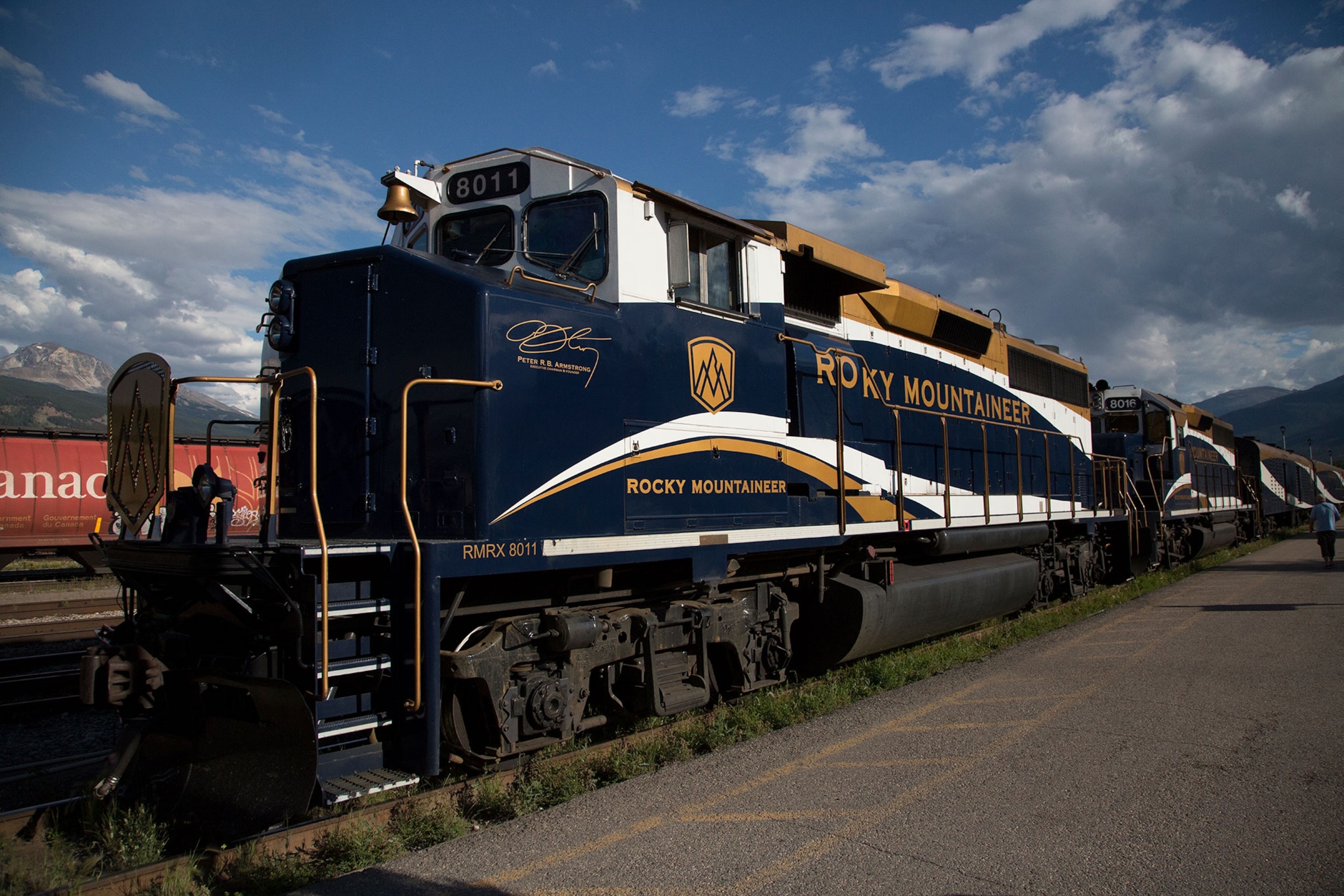 A stationary train with mountains in the background.