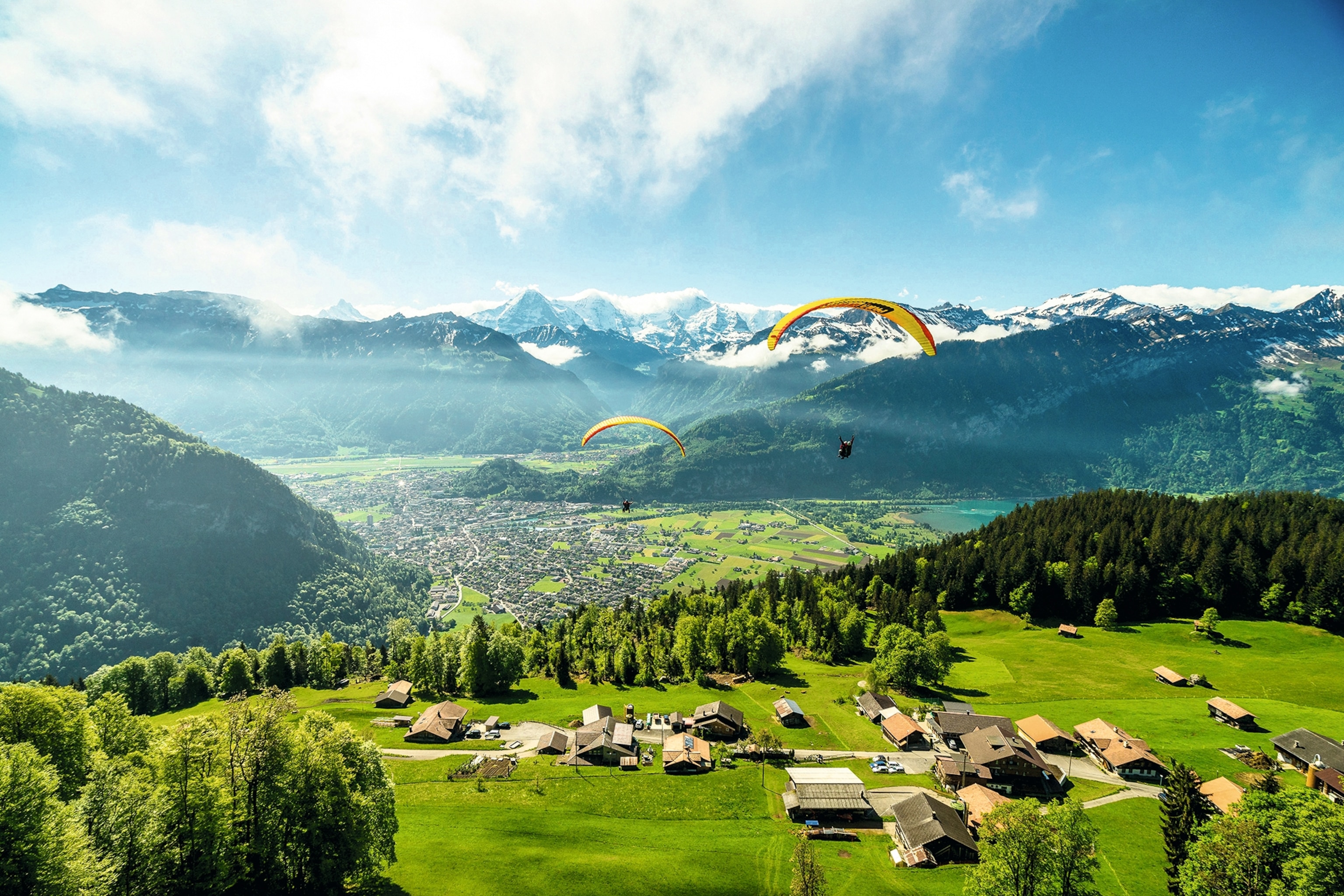 Two paragliders over Interlaken, a town in Switzerland.