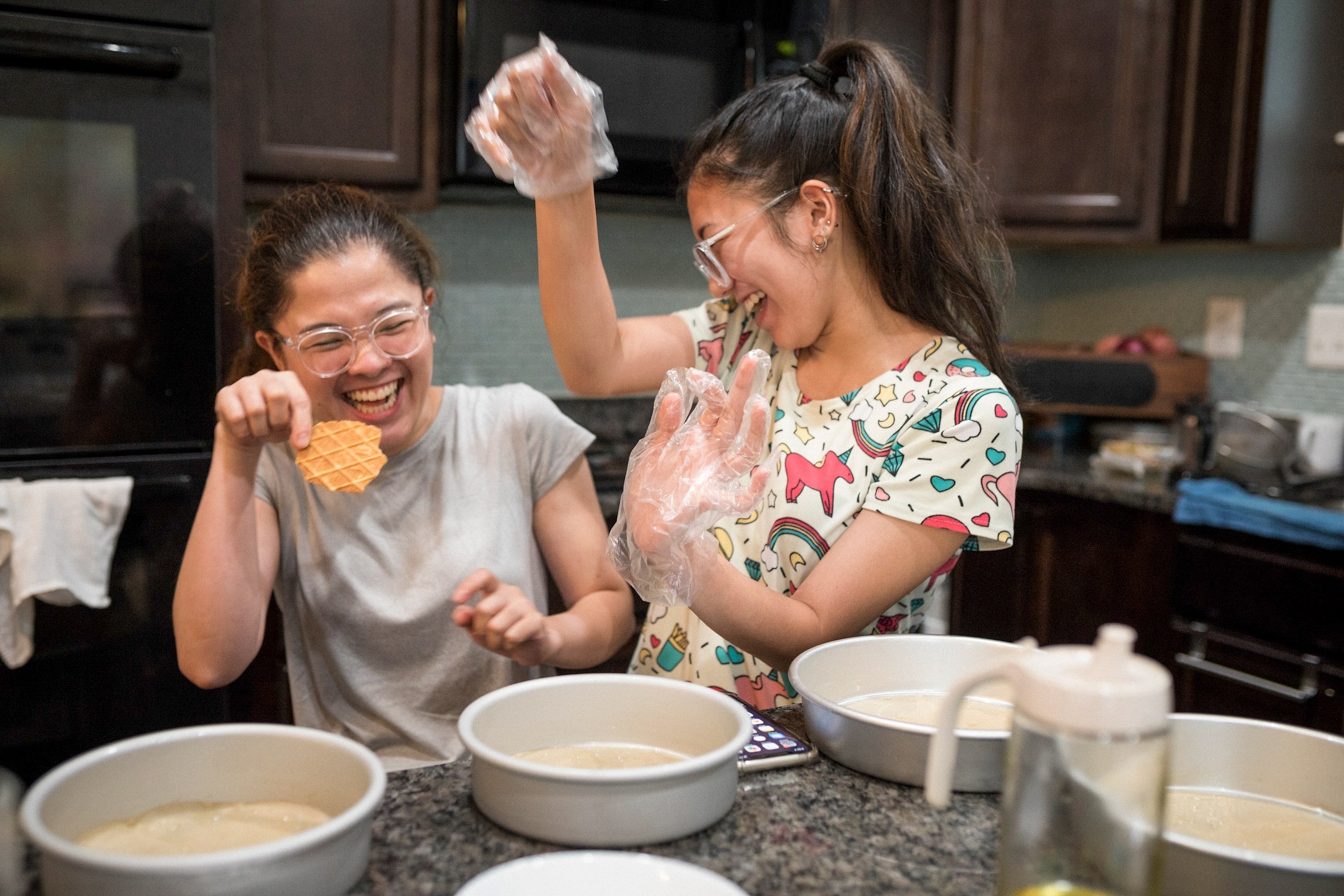Two sisters smile gleefully.
