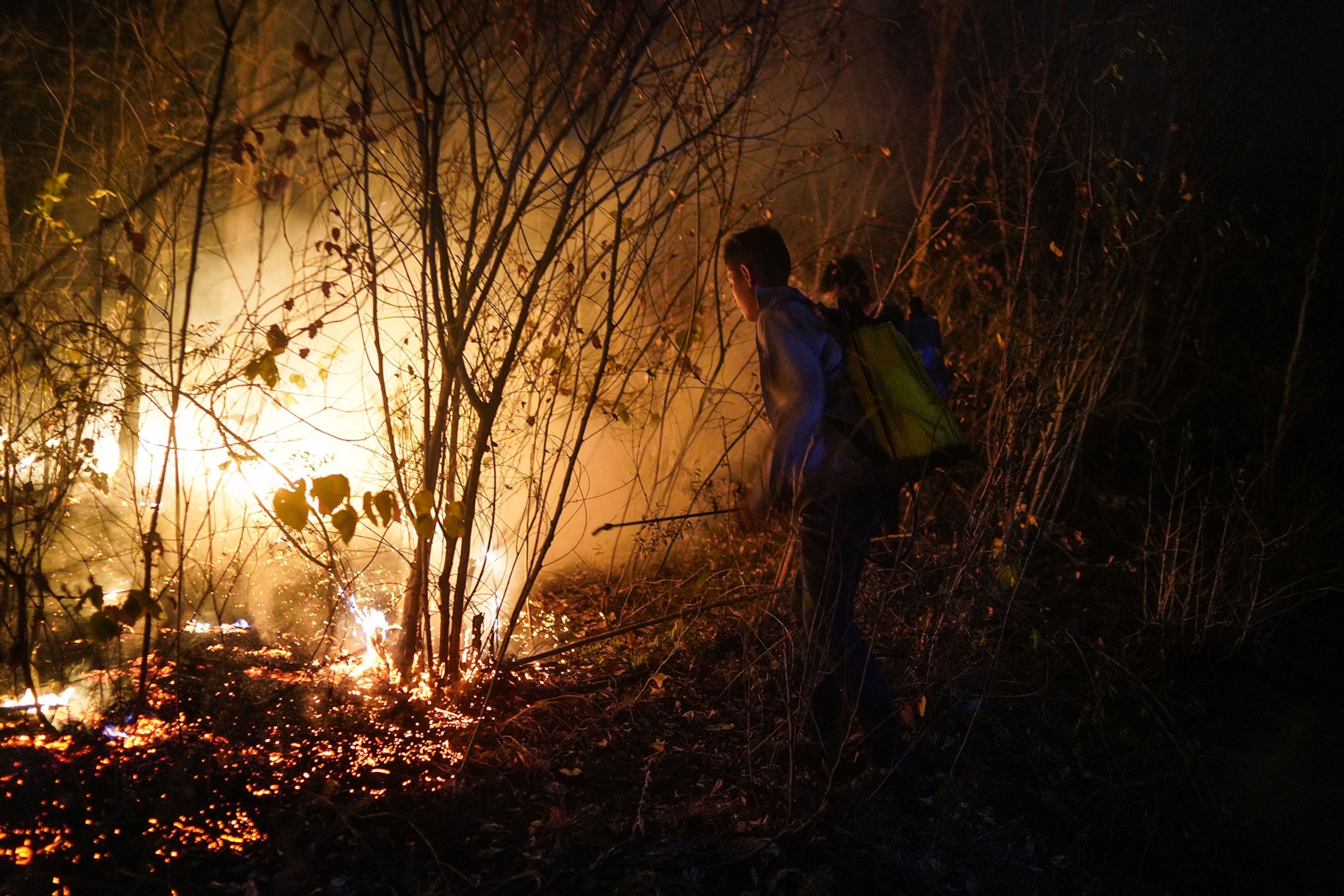 young volunteers putting out fires in the area