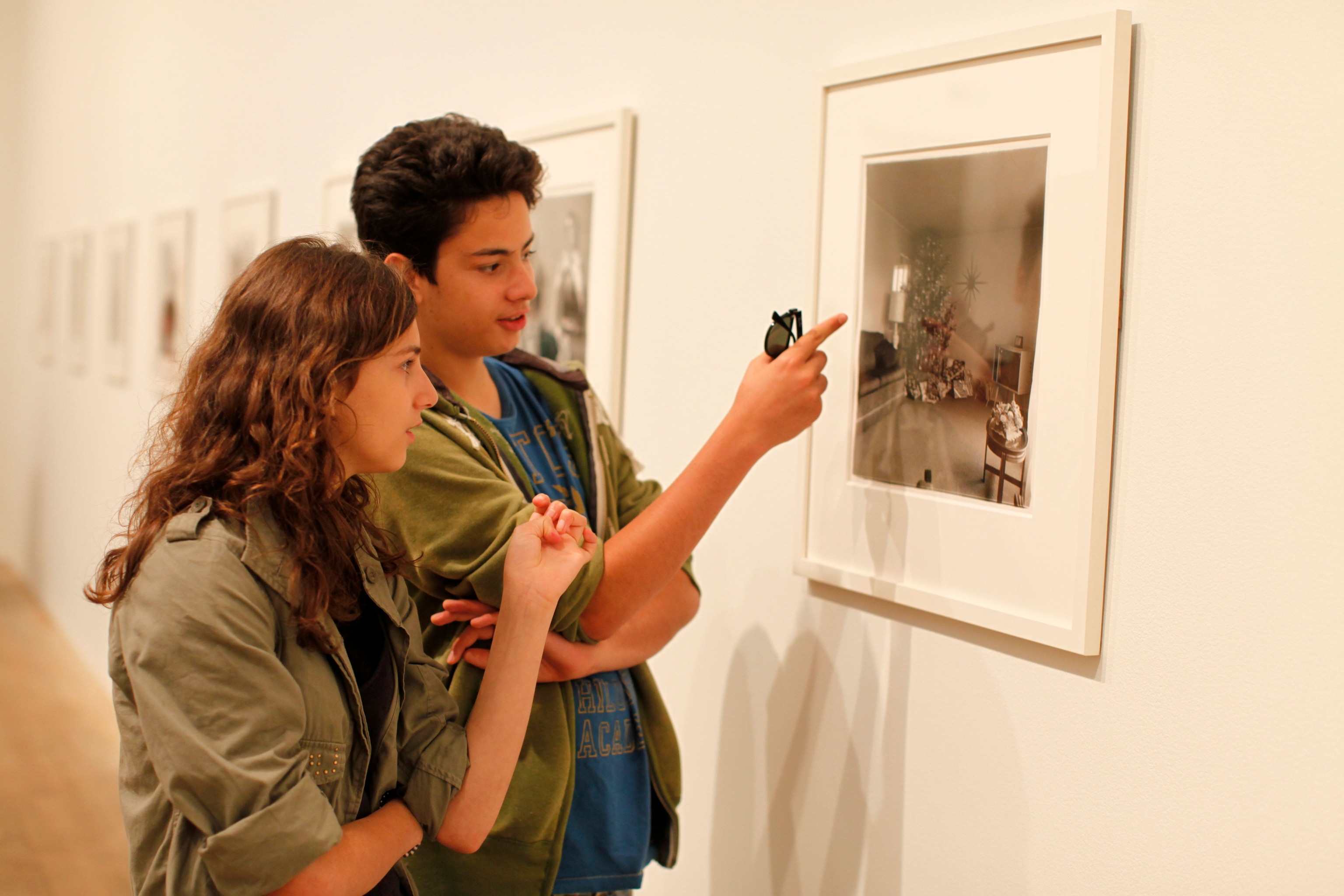 teenagers looking at picture within a gallery