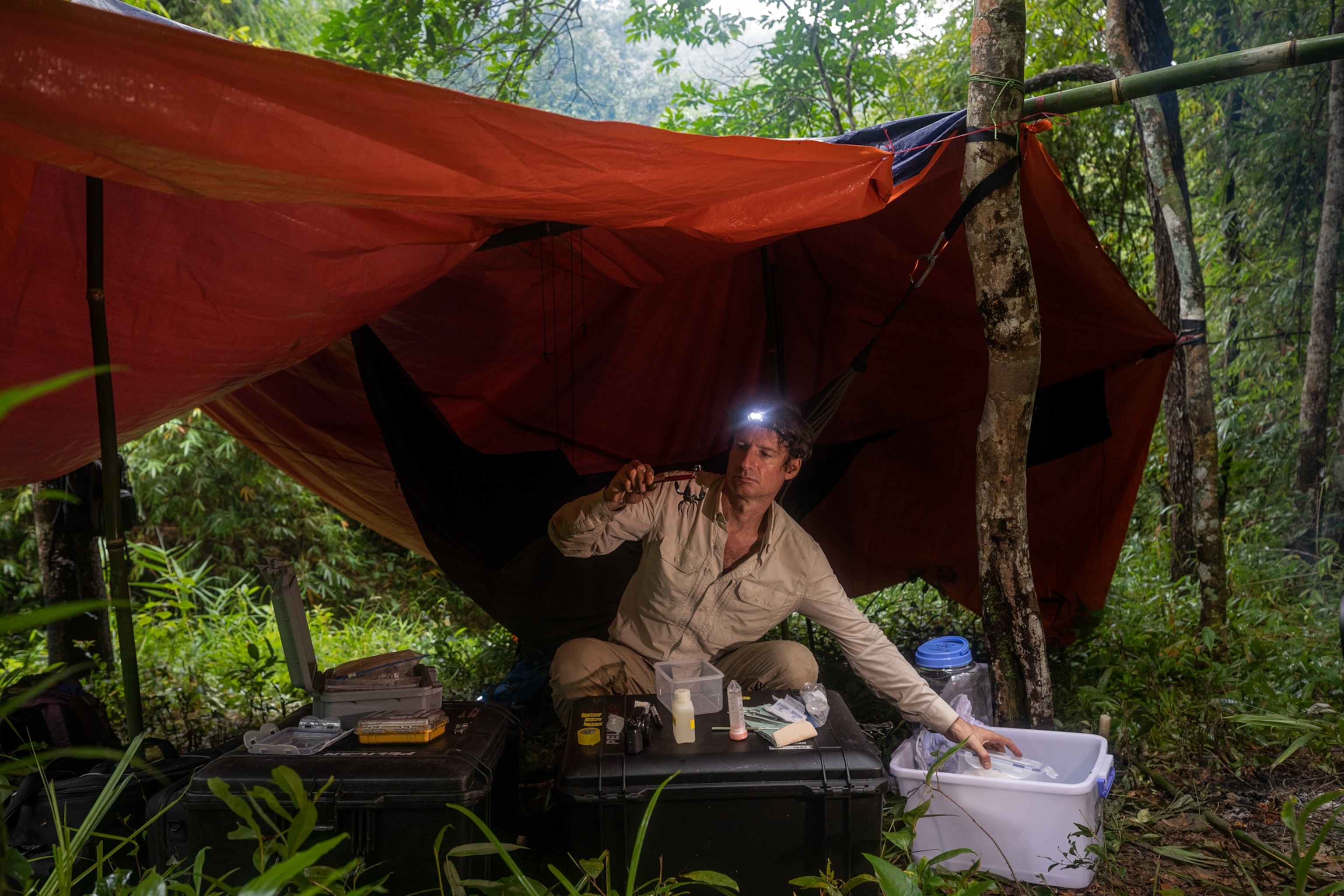 man under red canopy
