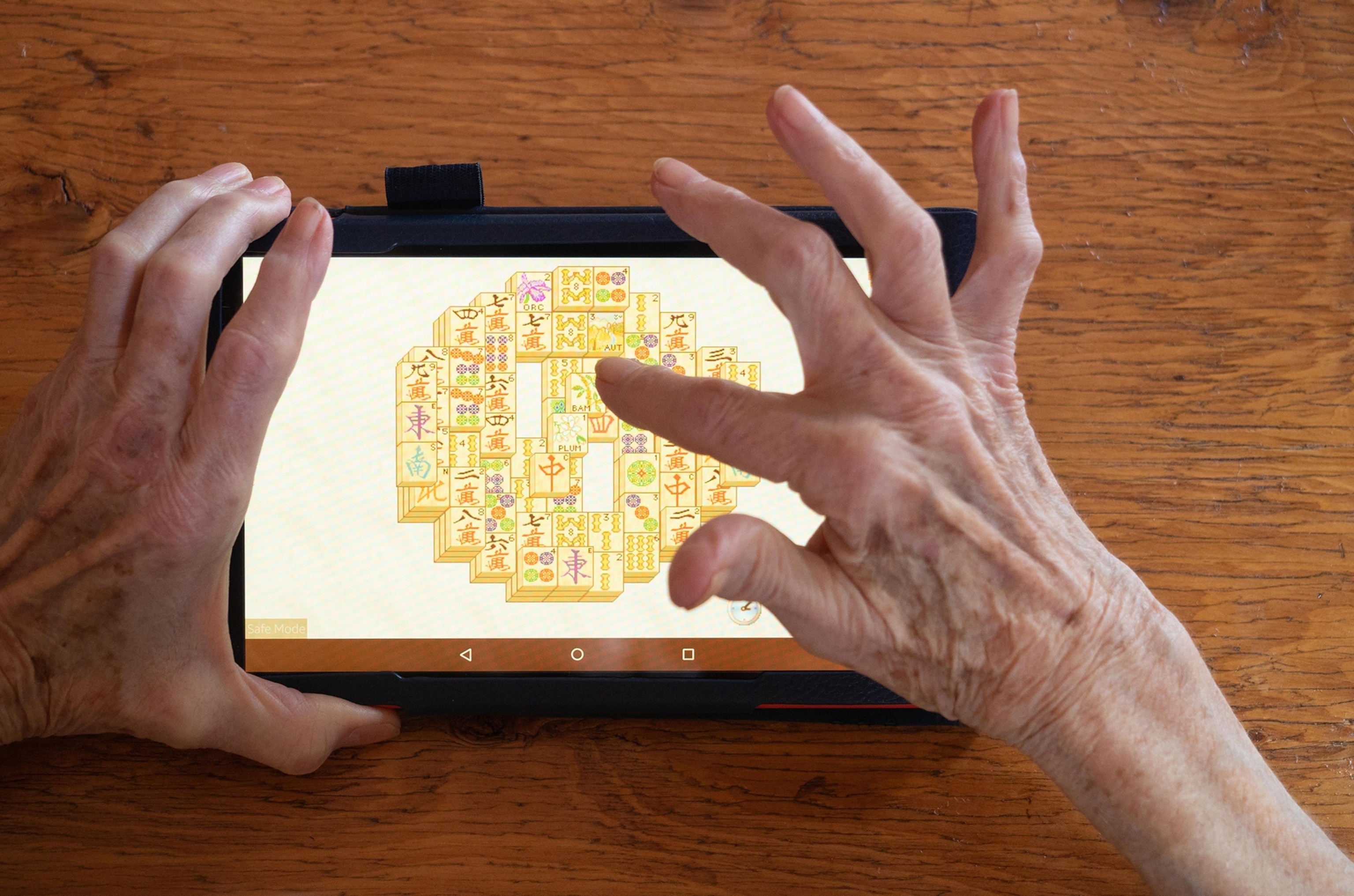Digital screen has mahjong tiles on it.