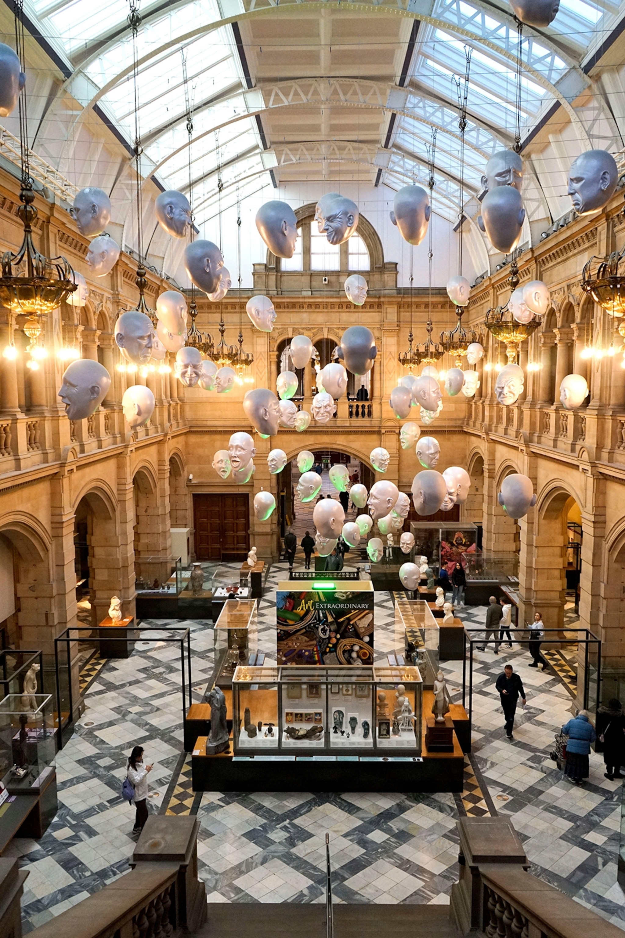An art installation of floating heads in the hall of Kelvingrove Art Gallery and Museum, Glasgow.