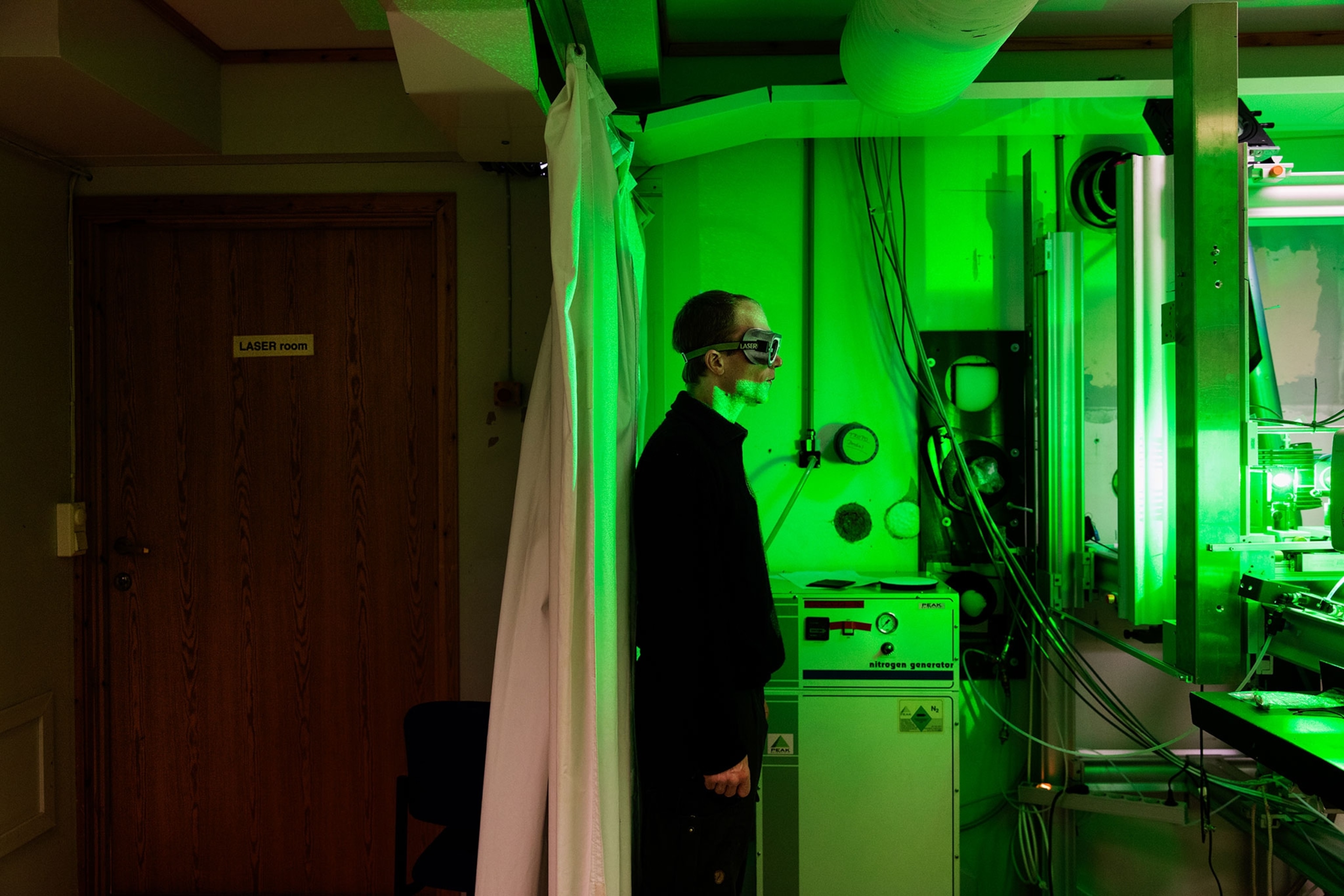 observatory engineer Rene Burgi operating a laser beam.